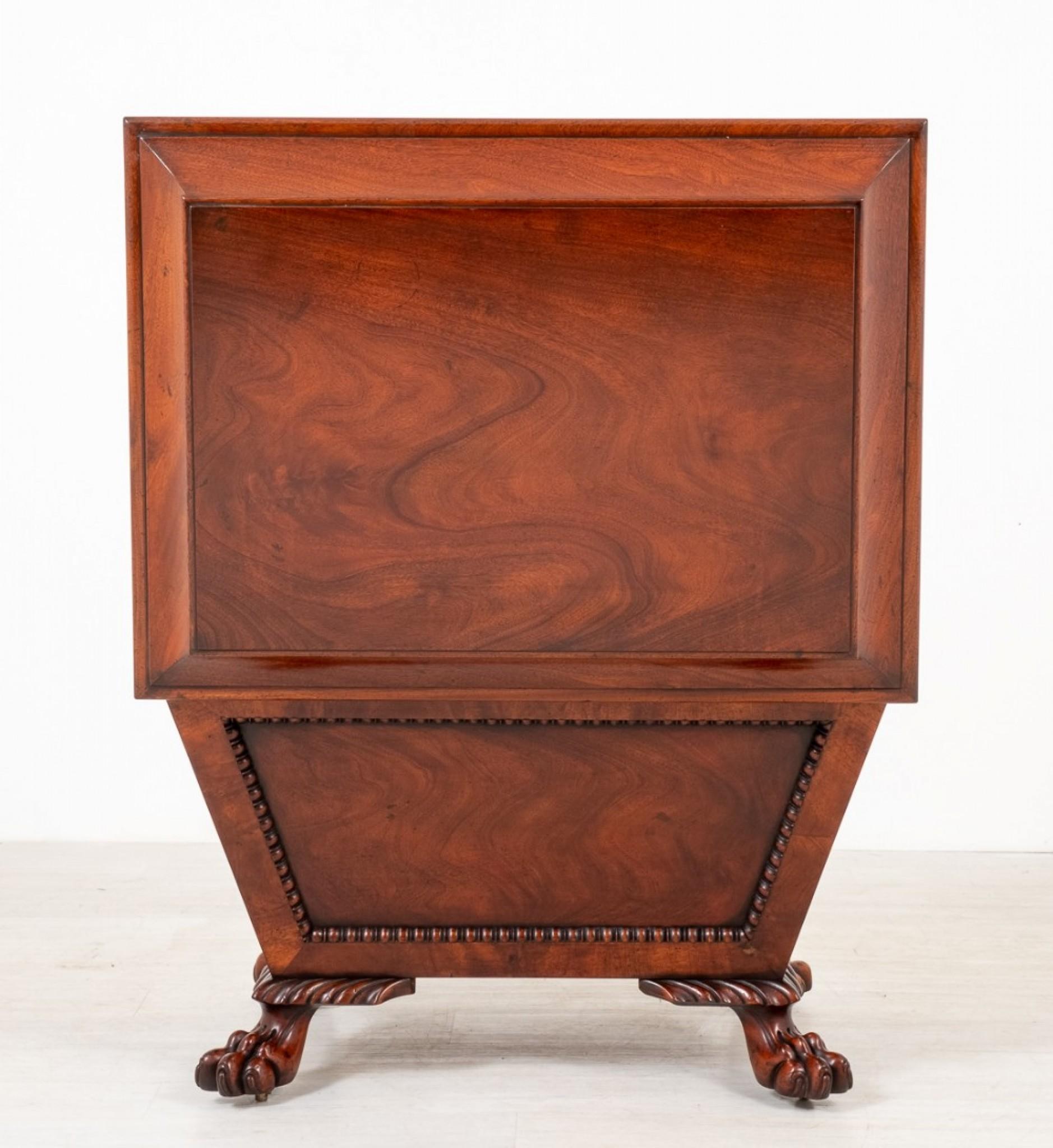 Regency style mahogany wine cooler.
This wine cooler is of sarcophagus form.
circa 1930
Raised upon boldly carved lions paw feet.
The wine cooler features highly figured mahogany panels with half turned mouldings and a shaped top.
Presented in