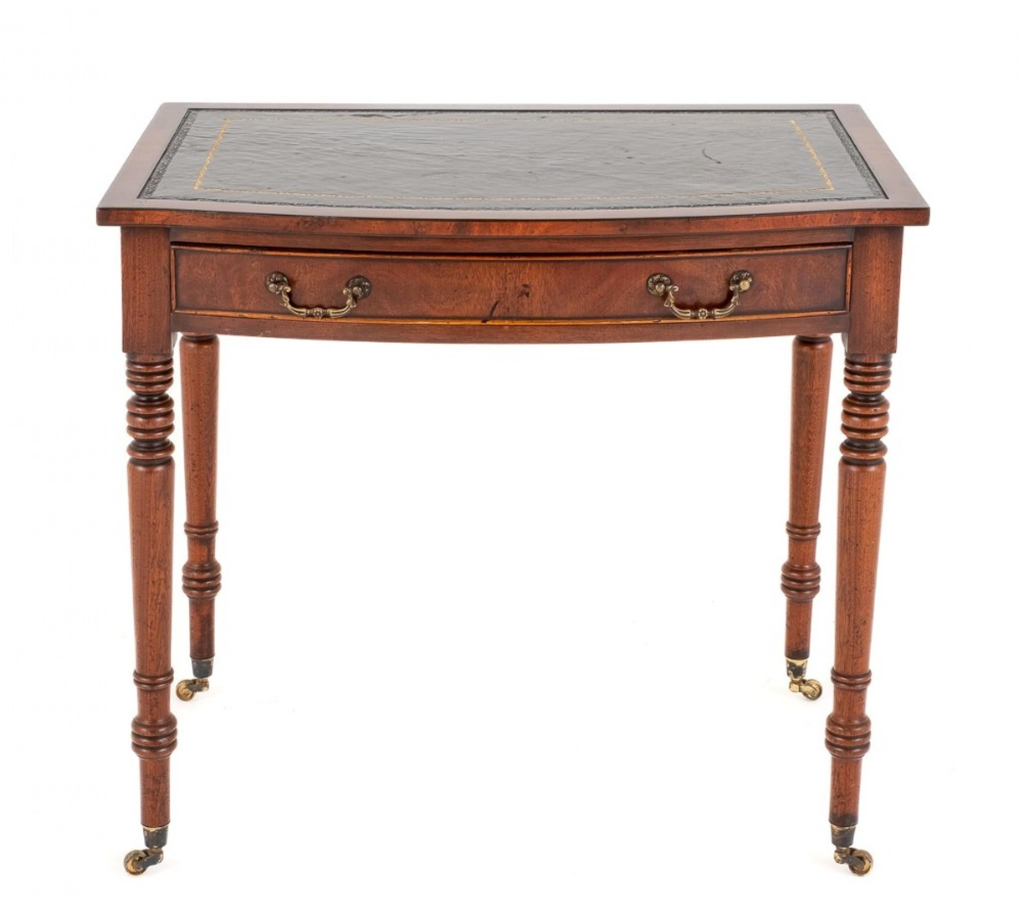 Mahogany Regency Revival 1 Drawer Writing Table.
This Rather Petite Writing Table is of a Bow Form.
Featuring 1 Oak Lined Drawer With Cast Brass Swan Neck Handles.
The Ring Turned Legs Being of a Typical Regency Influence Standing Upon Brass
