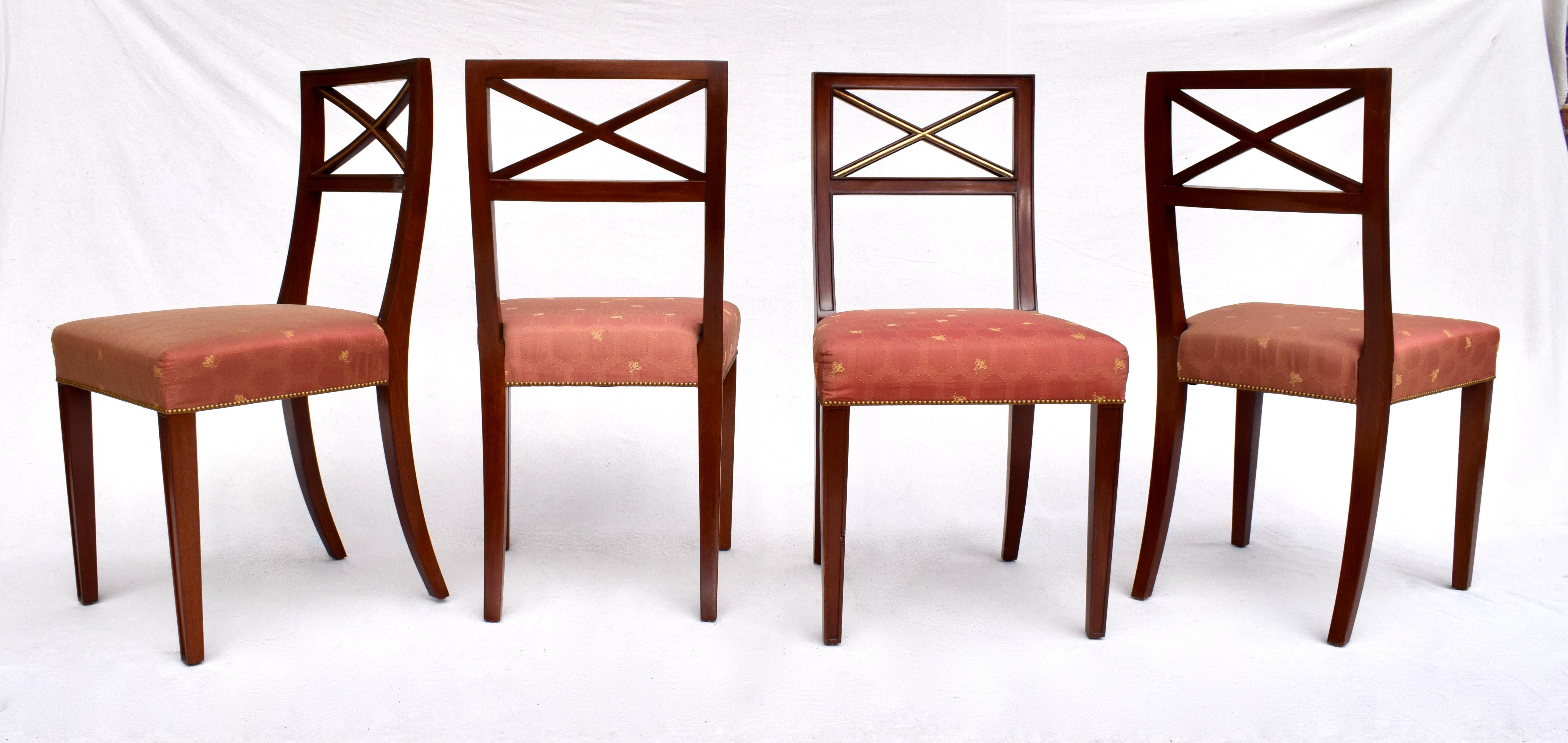 A striking set of six solid Mahogany parcel gilt X back dining chairs with distinct design elements as seen in the works of Thomas Pheasant for Baker & Tommi Parzinger. Includes Two cleverly designed re-curved arm chairs for comfortable dining and 4