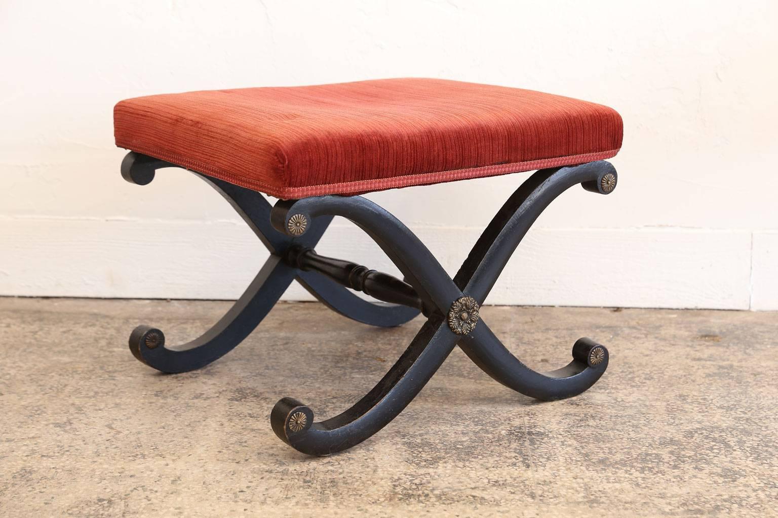 Regency X-frame stool, in its original ebonized finish and brass mounts. This extremely decorative English foot stool dates from circa 1810-1820 and is constructed from sturdy, strong mahogany. Upholstery is not new and ready to be recovered.