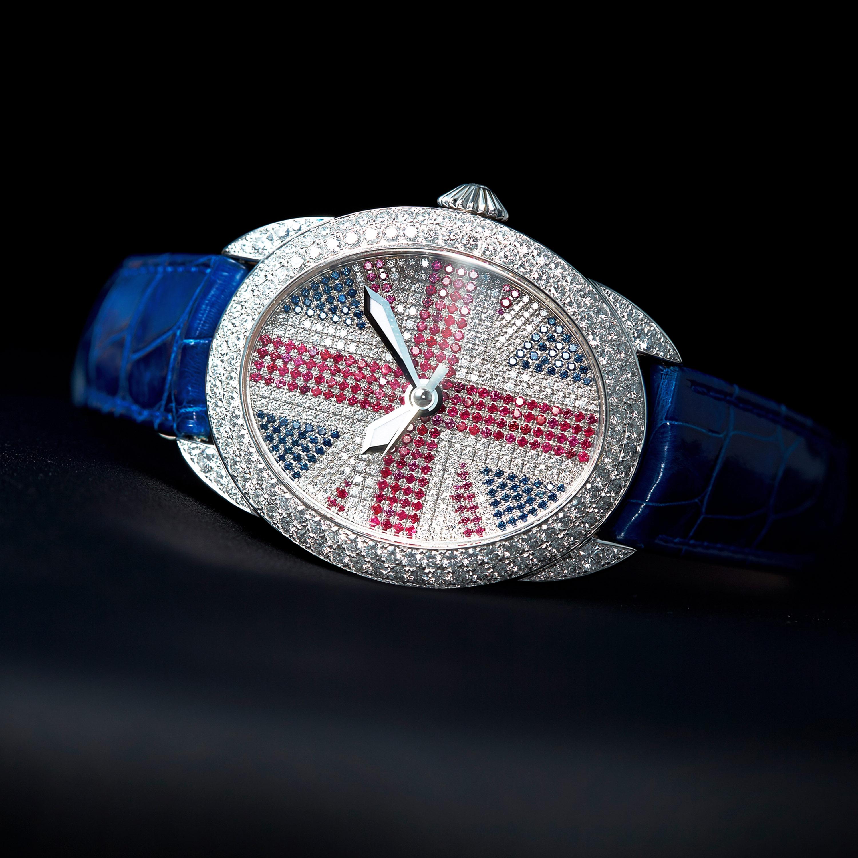 Regent Brexit 4047 is a luxury diamond watch for men crafted in Stainless Steel, featuring white oval dial, union jack motif set with rubies and sapphires, automatic movement. The case, dial and crown are set with white diamonds, red rubies and blue