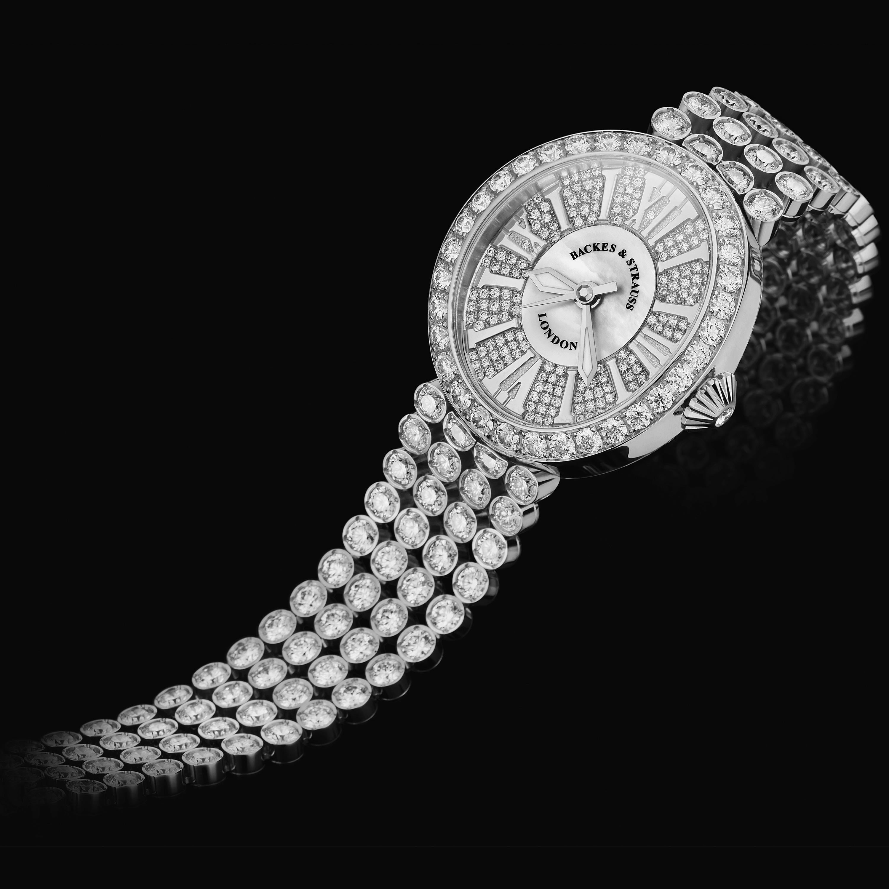 Regent Princess 3238 is a luxury diamond watch for women crafted in 18kt White gold, featuring the mother-of-pearl oval dial with the white gold roman numerals, quartz movement. The case, dial and the crown are set with white Ideal Cut diamonds. It