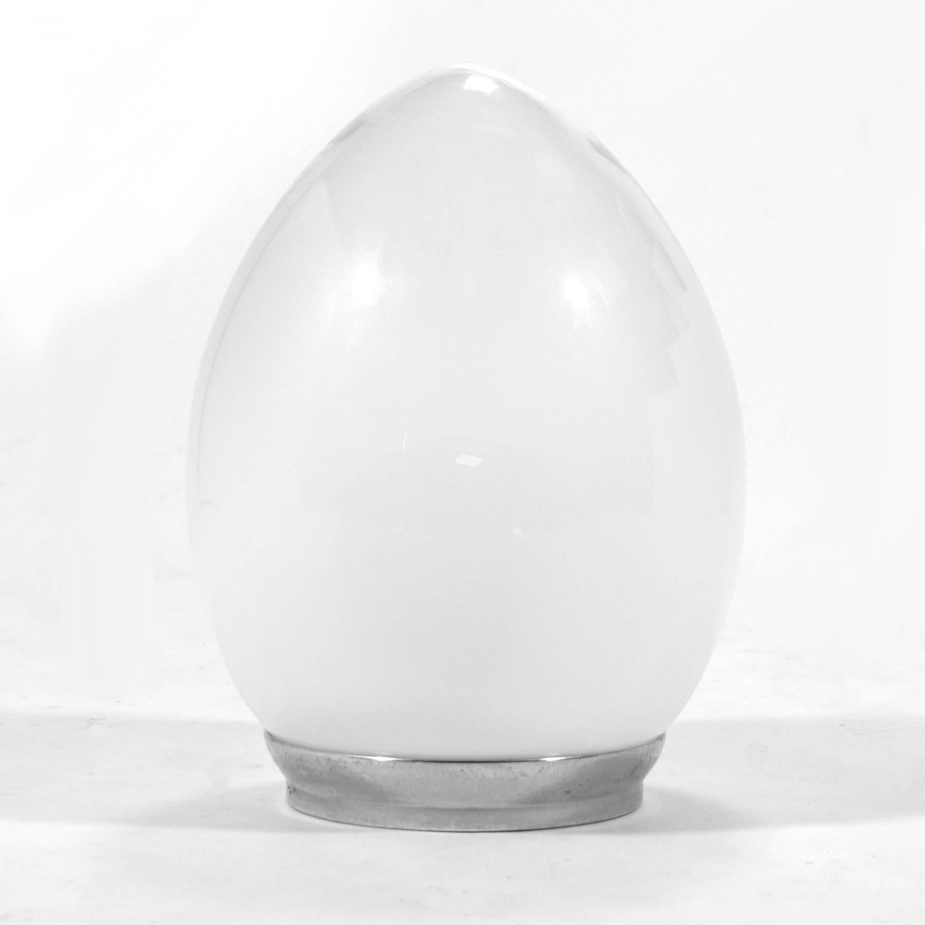 A delightful design from Italy, this Reggiani lamp has a translucent white globe diffuser within a much larger egg shaped glass shade which transitions from clear to a translucent white. The effect is an elegant lamp of subtle beauty.
