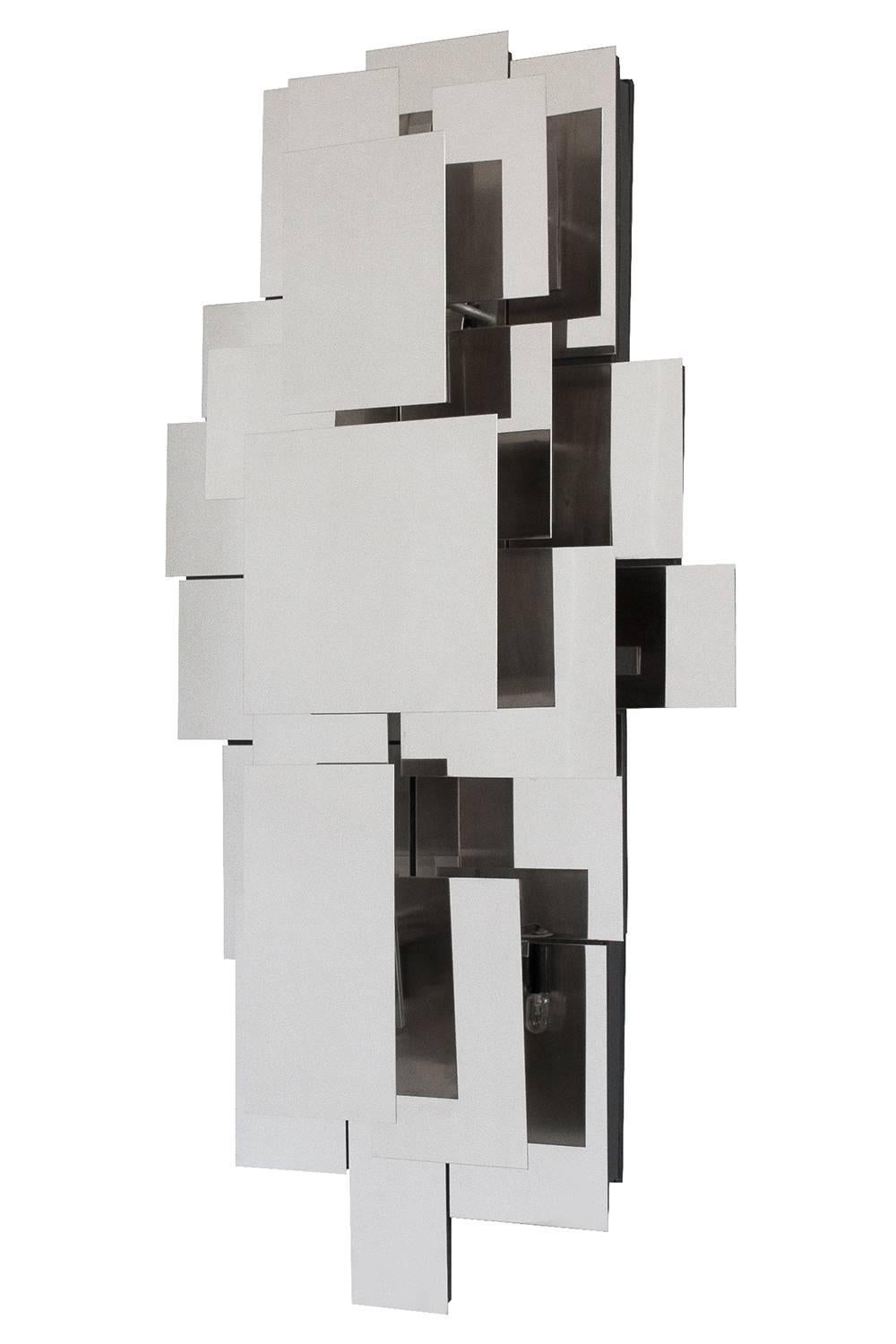 Unique Reggiani style polished steel wall light sculpture or sconce. Layered asymmetrical mirror polished steel rectangular forms conceal five candelabra base light bulbs. The light sculpture operates by touch. Touch any metal part to engage the