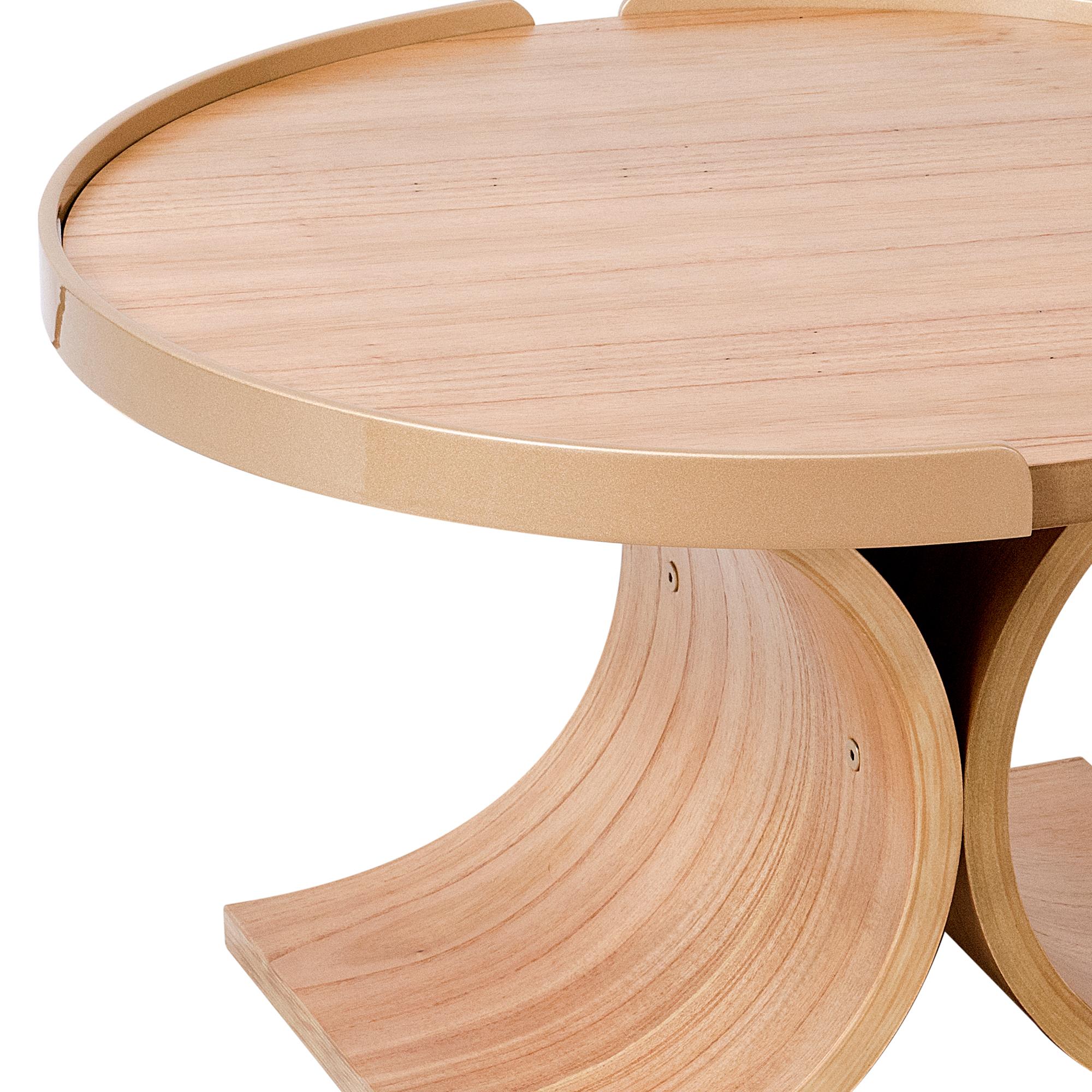The Regia center table has a base made of a curved cinnamon natural wood multi-laminate. (20mm thick)
The top is made of the same wood and finish, cinnamon.  In the edges there are two semi circles made of carbon steel painted with matte gold