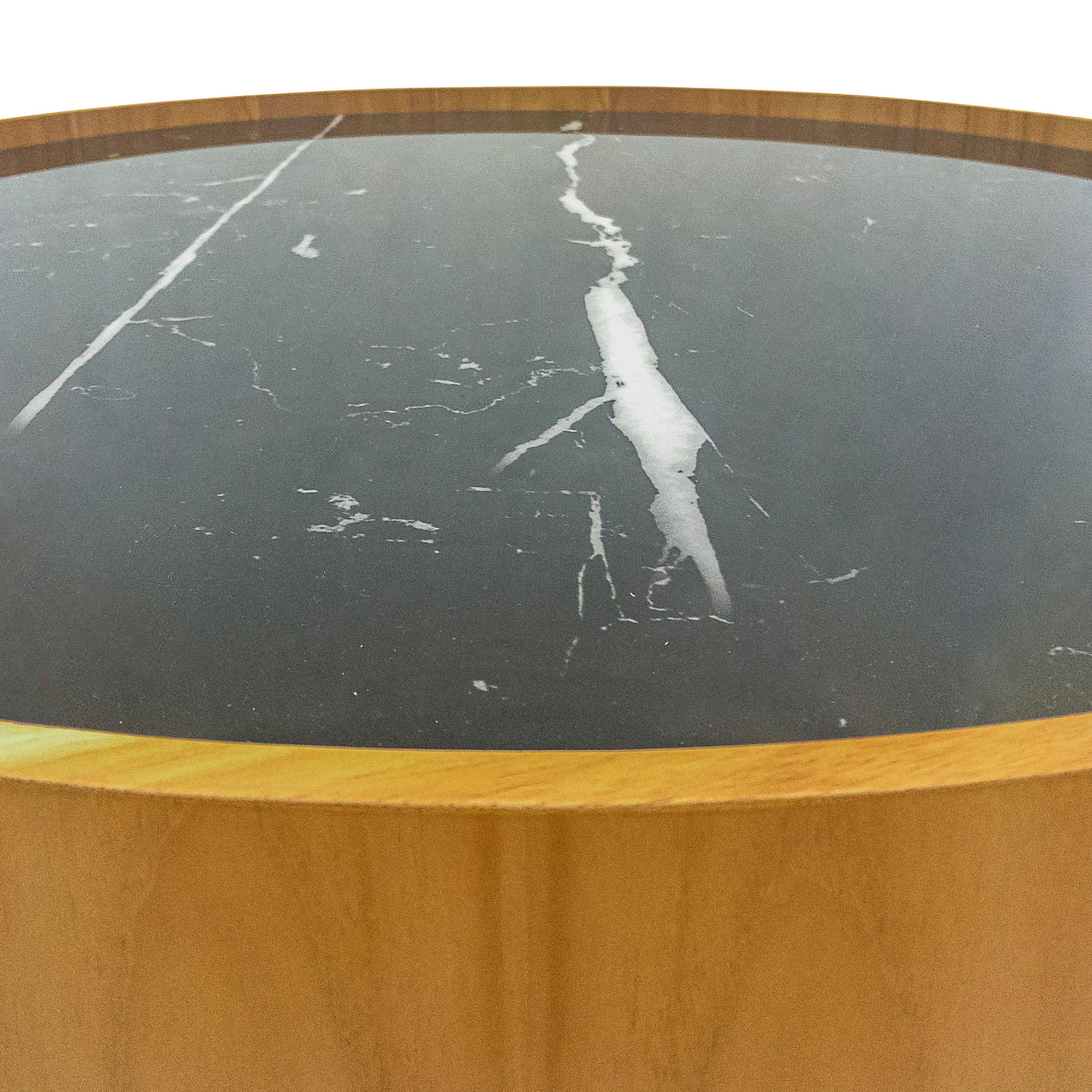 The stunning Regia occasional tables consist of a set of two tables with varying diameters and heights. The tabletop is black nero glass that imitates a beautiful black marble with white veins running through it. Combined with a Teak rim and