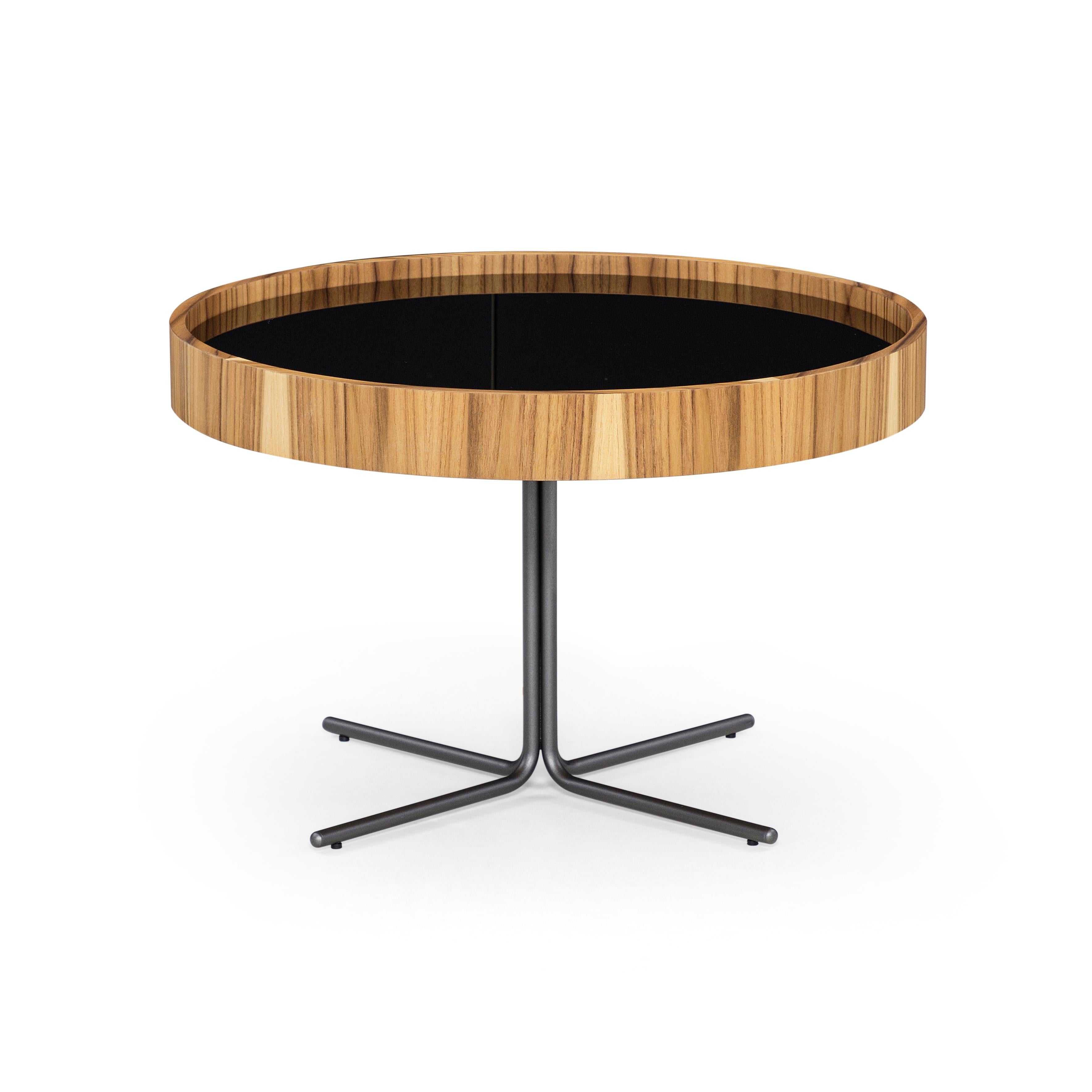 The stunning Regia occasional tables consist of a set of two tables with varying diameters and heights. The tabletop is black Nero glass. Combined with a Teak rim and stainless steel legs with a polished finish. The Regia set of tables is yet