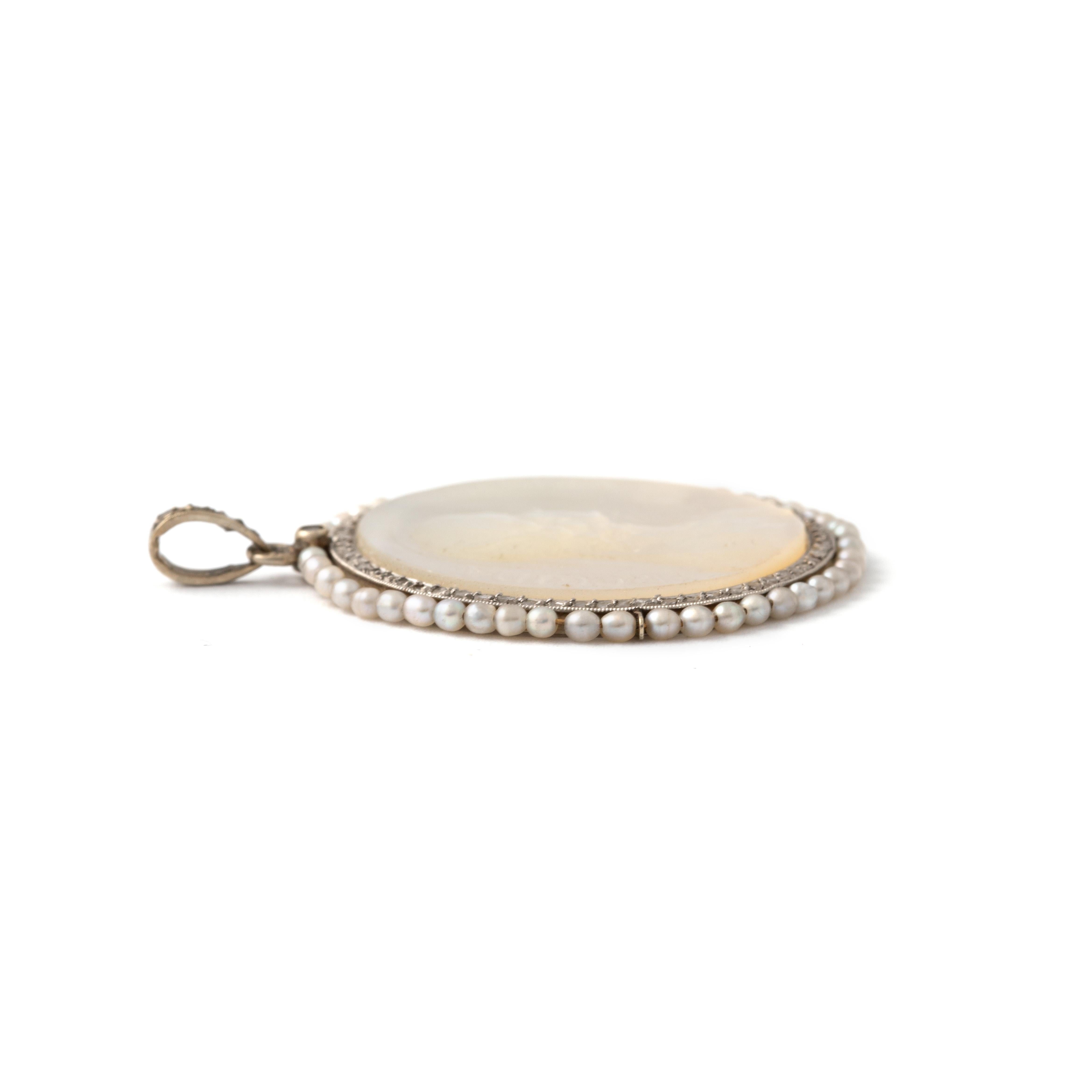 Mother-of-Pearl, rose-cut Diamond and Pearl on White Gold Pendant representing Regina Caeli. 
20th Century.

Total length: approx. 3.70 centimeters / 1.46 inches.
Total width: approx. 3.00 centimeters / 1.18 inches.

Total weight: 6.18 grams.
