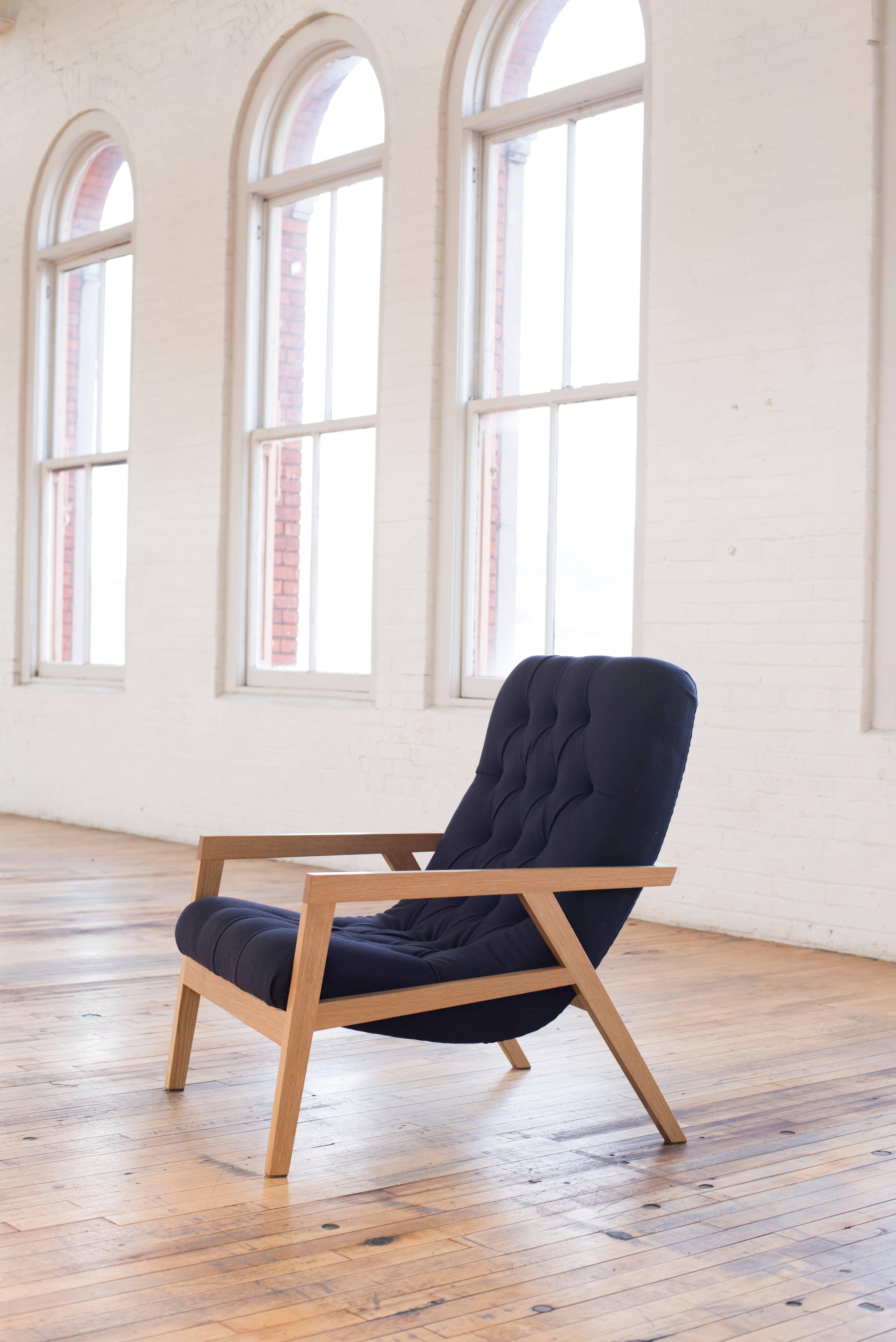The Regina Lounge is a handcrafted, modern contemporary lounge chair with a solid wood frame that cradles a simple curved laminated plywood shell, hidden under layers of foam and traditional diamond tufted leather or wool. Incredibly comfortable,