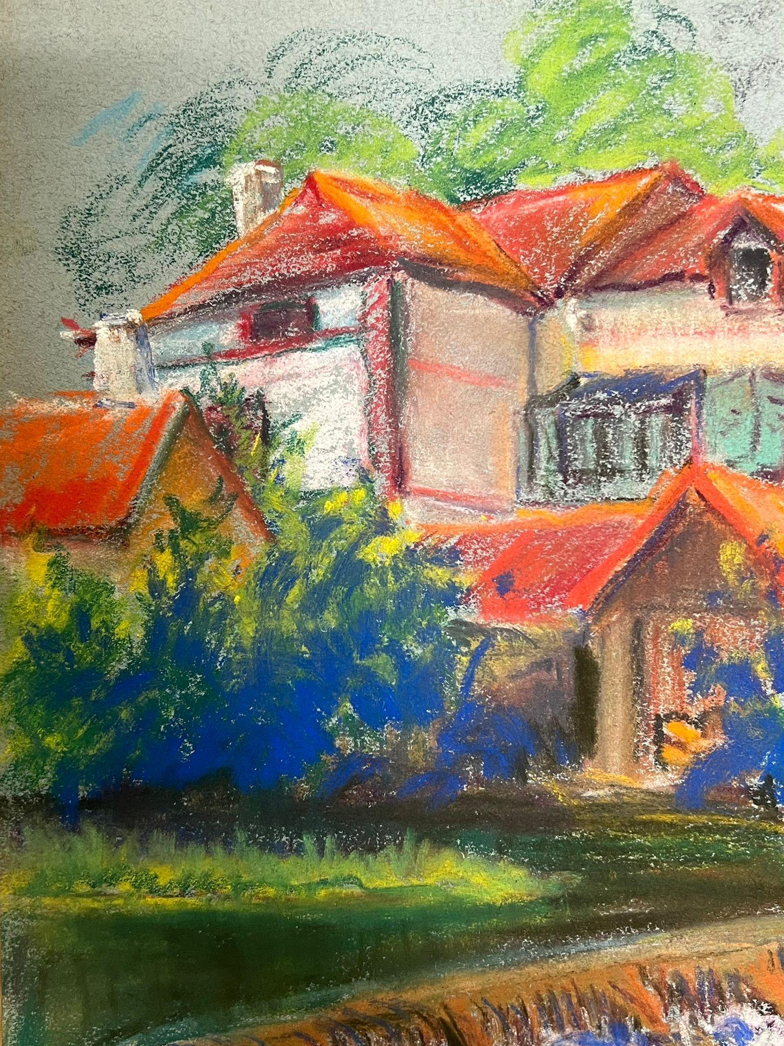 Colorful Village Landscape 
by Regine David (female French artist, 1910-2018)
pastel painting on artist paper
painting: 13 x 10 inches
condition: This painting is in excellent condition, with vibrant colors and well-preserved details. The painting