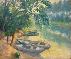 Resting Rowboats by a Shaded Riverbank A Tranquil Waterway Scene with Lush Trees