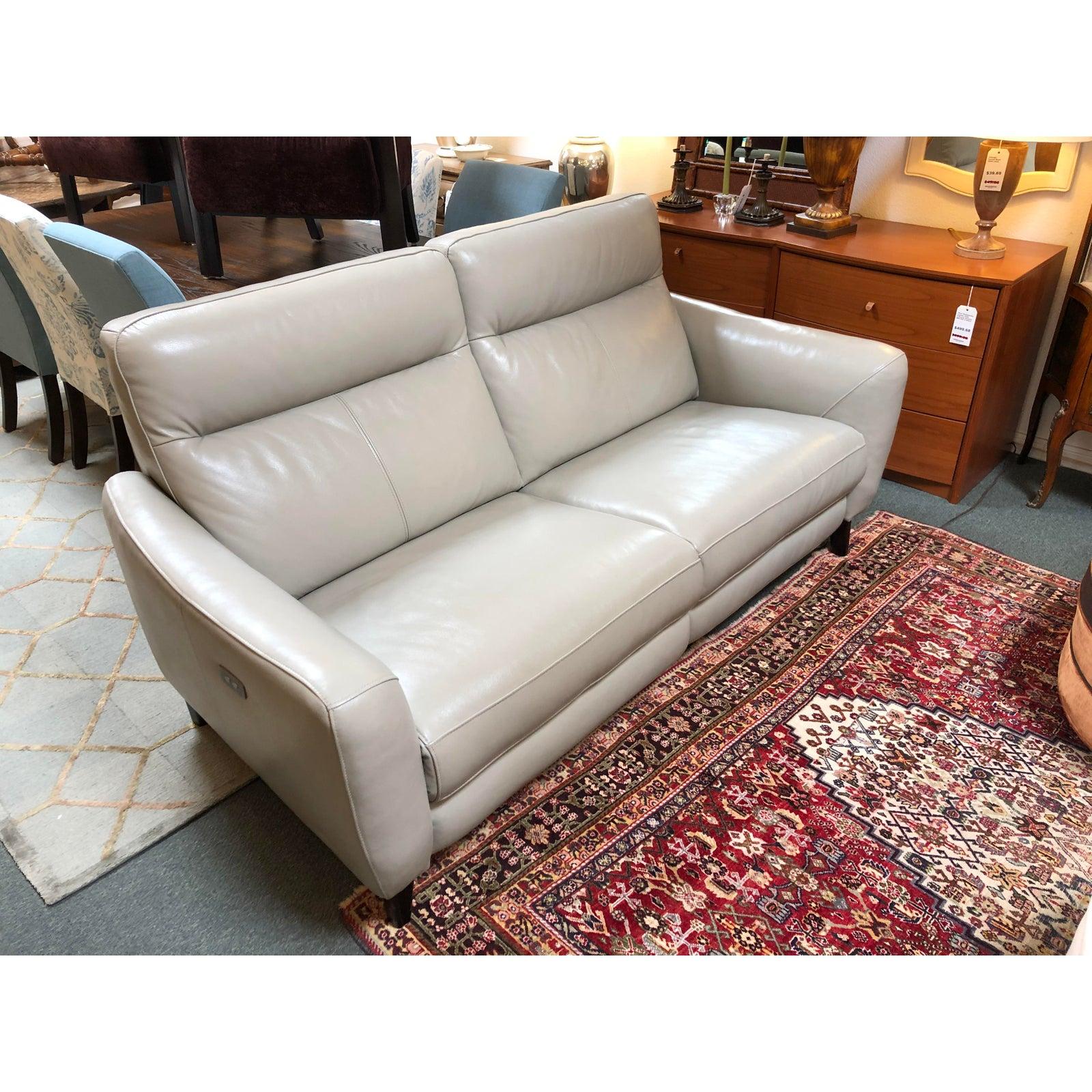 The Regine leather sofa by Scandinavian sesigns. Beautiful dove gray leather with detailed stitching envelopes one in head to toe comfort and contemporary style. Finished with tapered legs in solid hardwood.

Measures: Arm 25.5”
Seat 18”.