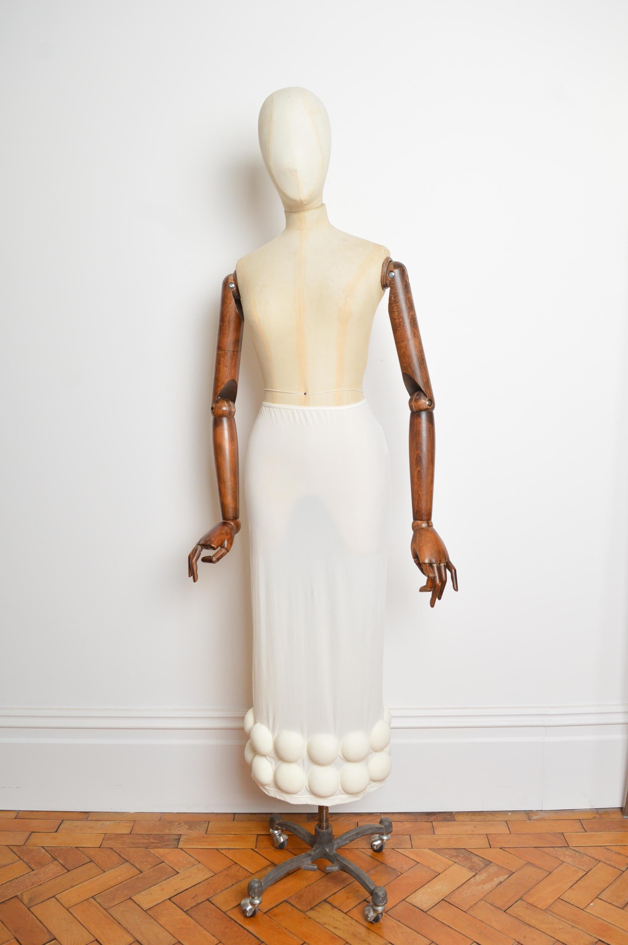 Avant Guard 2007 COMME des GARÇONS by Rei Kawakubo cream mesh tube skirt with bizarre Tennis ball like spherical foam detailed hem.
Features;
Stretchy elasticated fit
Semi Sheer texture
High waisted elasticated hem
Archival Runway piece
Recommended