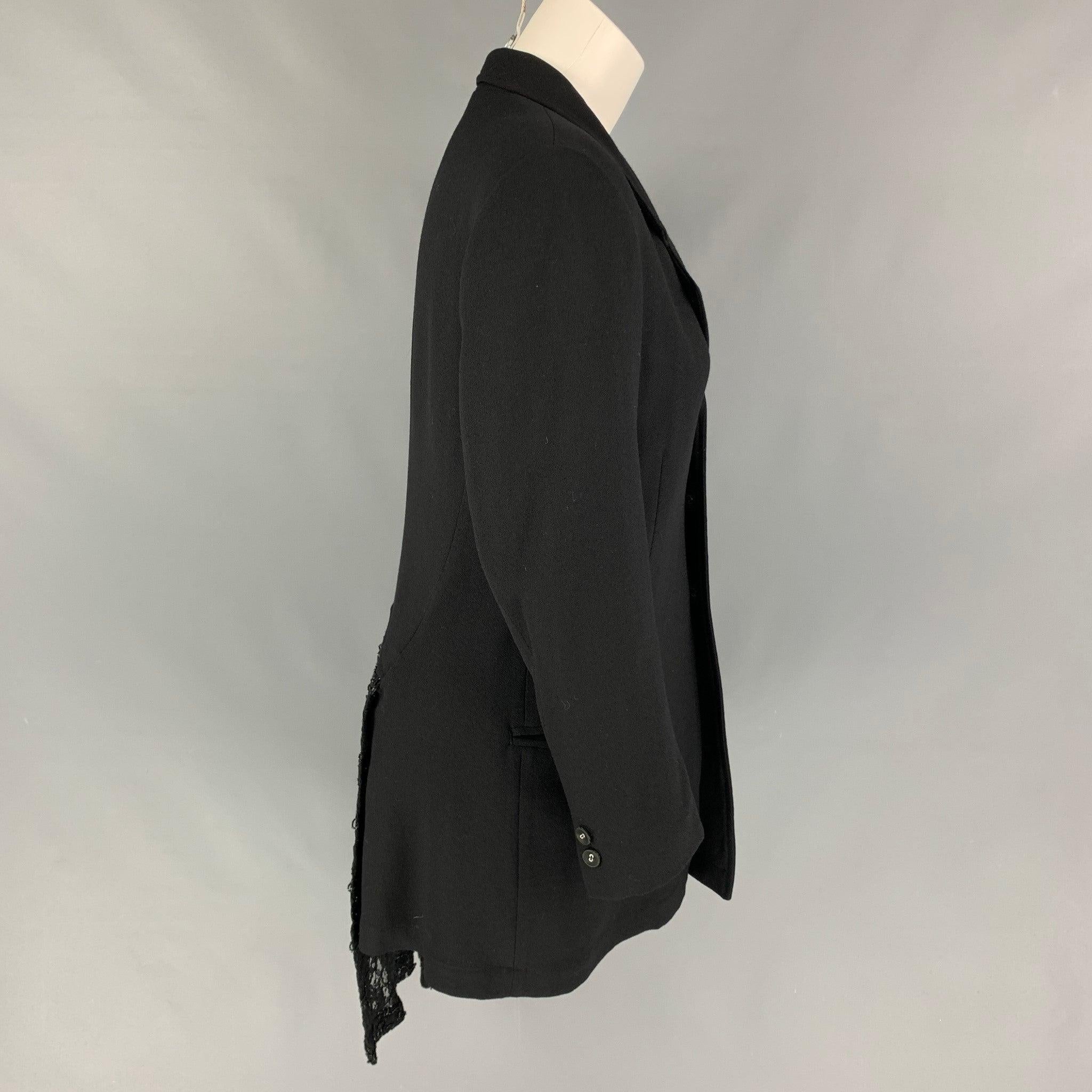 REI KAWAKUBO jacket comes in a black wool with a half liner featuring a notch lapel, ruffled lace trim, slit pocket detail, and a buttoned closure. Made in Japan.
Very Good
Pre-Owned Condition. 

Marked:   M  

Measurements: 
 
Shoulder: 16 inches 