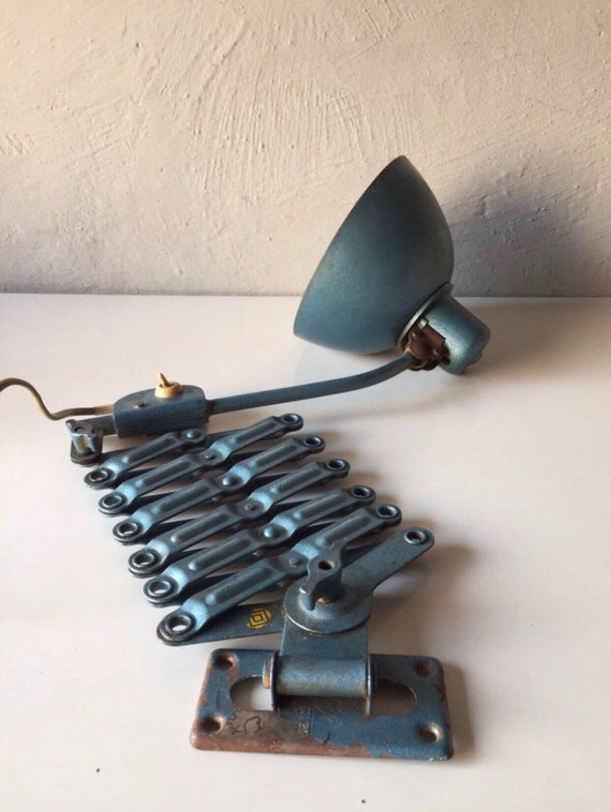 Brand: Reif Dresden, 1950s, East Germany
Betr-Nr. 1231/3507 

This Bauhaus artist studio wall and industrial lamp is made of a heavy blue metal body.
Works with E27 type of bulbs.
 