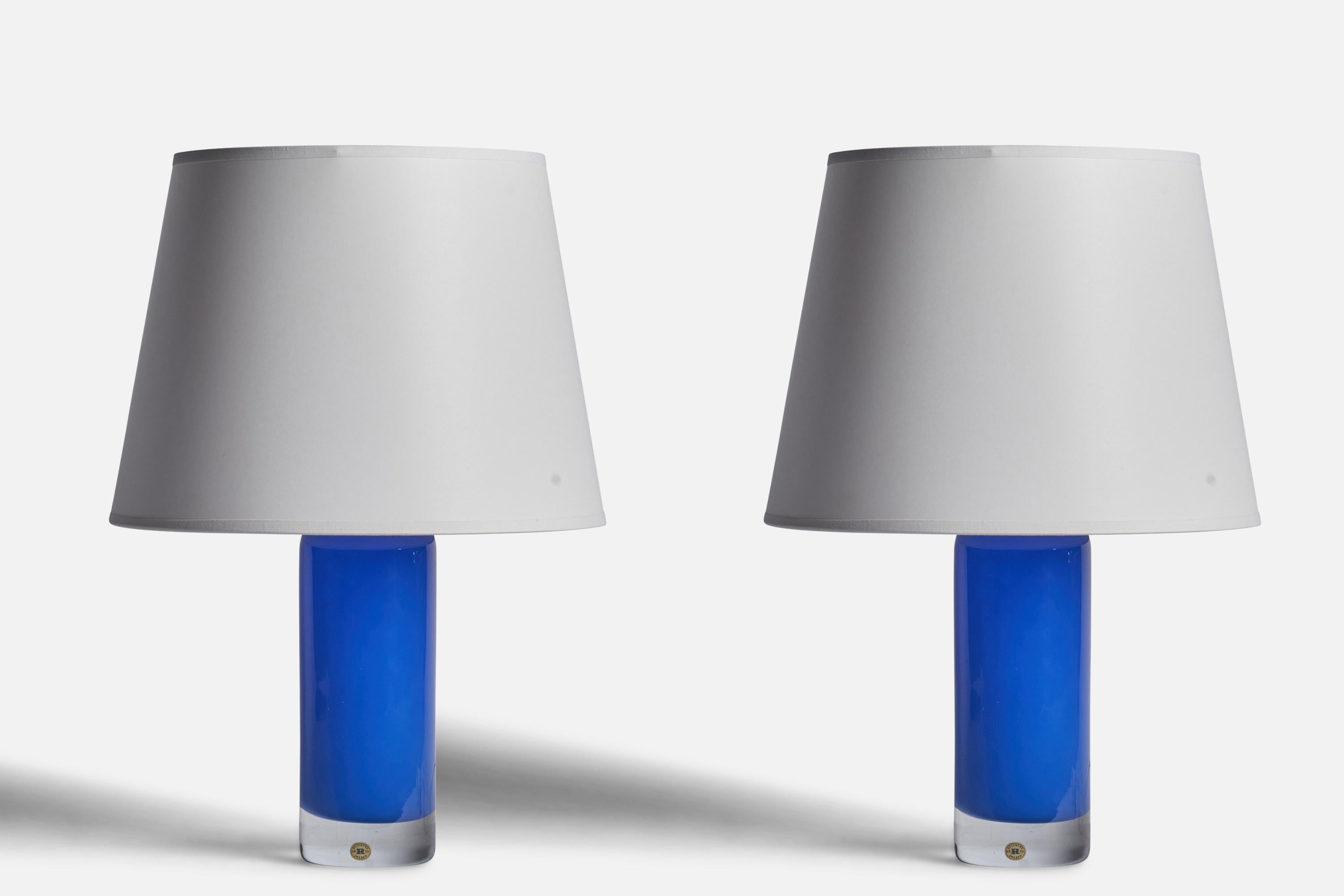 A pair of blue-coloured glass table lamps produced by Reijmyre Glasbruk, Sweden, 1950s.

Dimensions of Lamp (inches): 12” H x 3.15” Diameter
Dimensions of Shade (inches): 9” Top Diameter x 12” Bottom Diameter x 9” H
Dimensions of Lamp with Shade
