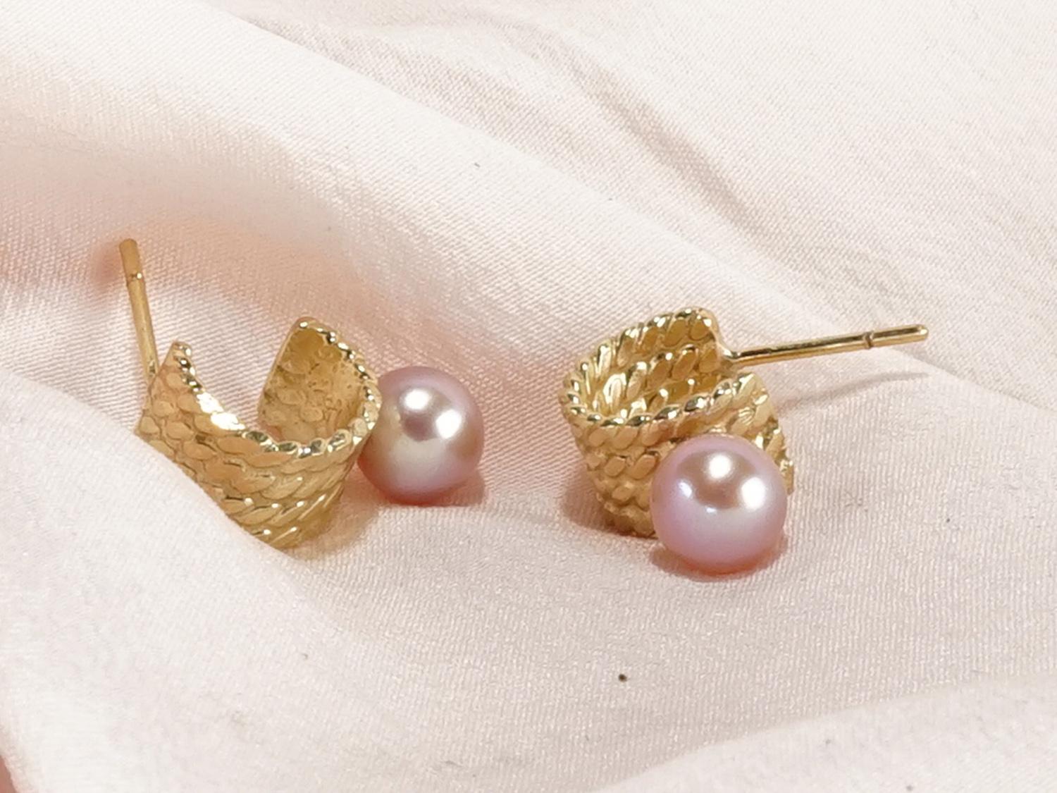 Reina 14K Recycled Yellow Gold Freshwater Pearl Earring by Mon Pilar.

Feminine and unique, these braided hoops are the perfect alternative to the classic pearl earring. Meant to fit just below the earlobe, they feature large freshwater pearls in a