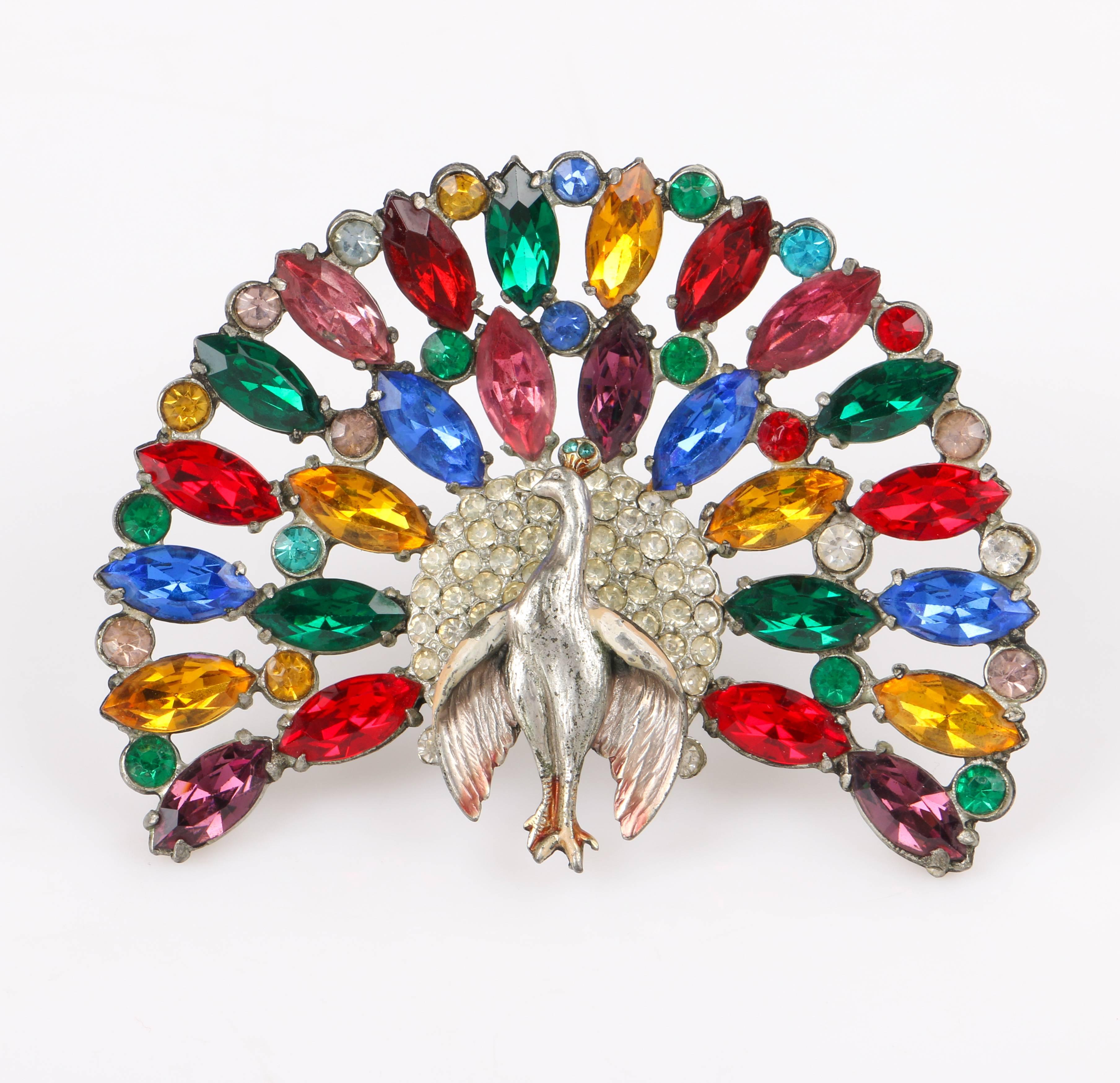 Vintage Reinad c.1930's large cut steel multi-color glass paste rhinestone peacock brooch. Open work cut steel setting with two rows of multi-color prong set navette and circular paste glass rhinestones fanned out above a central pave set rhinestone