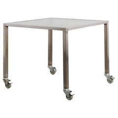 Reinforced glass and stainless steel desk on castors by Thomas Wendtland