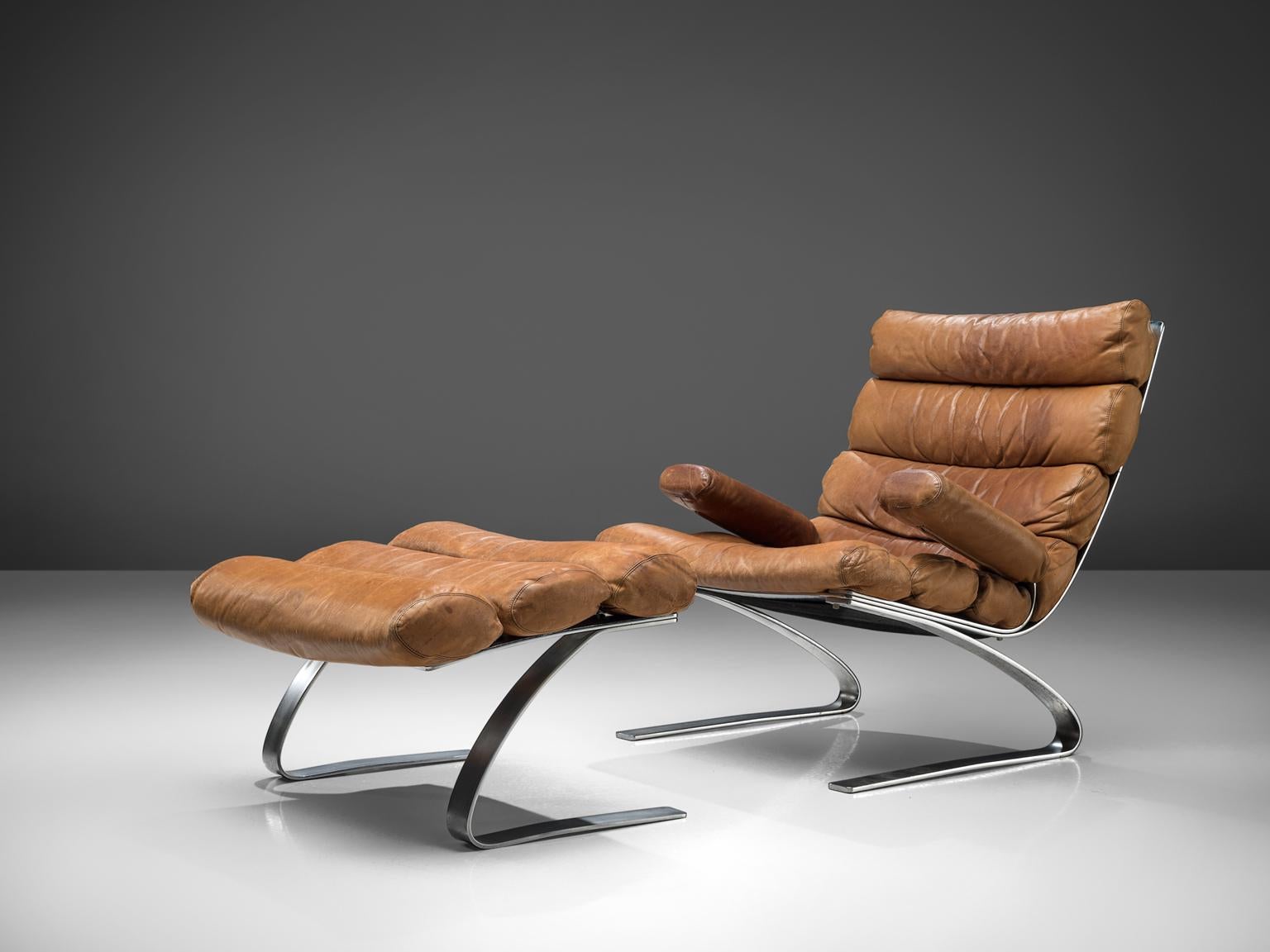 Reinhold Adolf and Hans-Jürgen Schräpfer for COR, lounge chair and pouf, cognac leather, steel, Germany, 1976.

This comfortable chair is designed by Reinhold Adolf and Hans-Jürgen Schräpfer for COR. The chair is designed as part of the Sinus