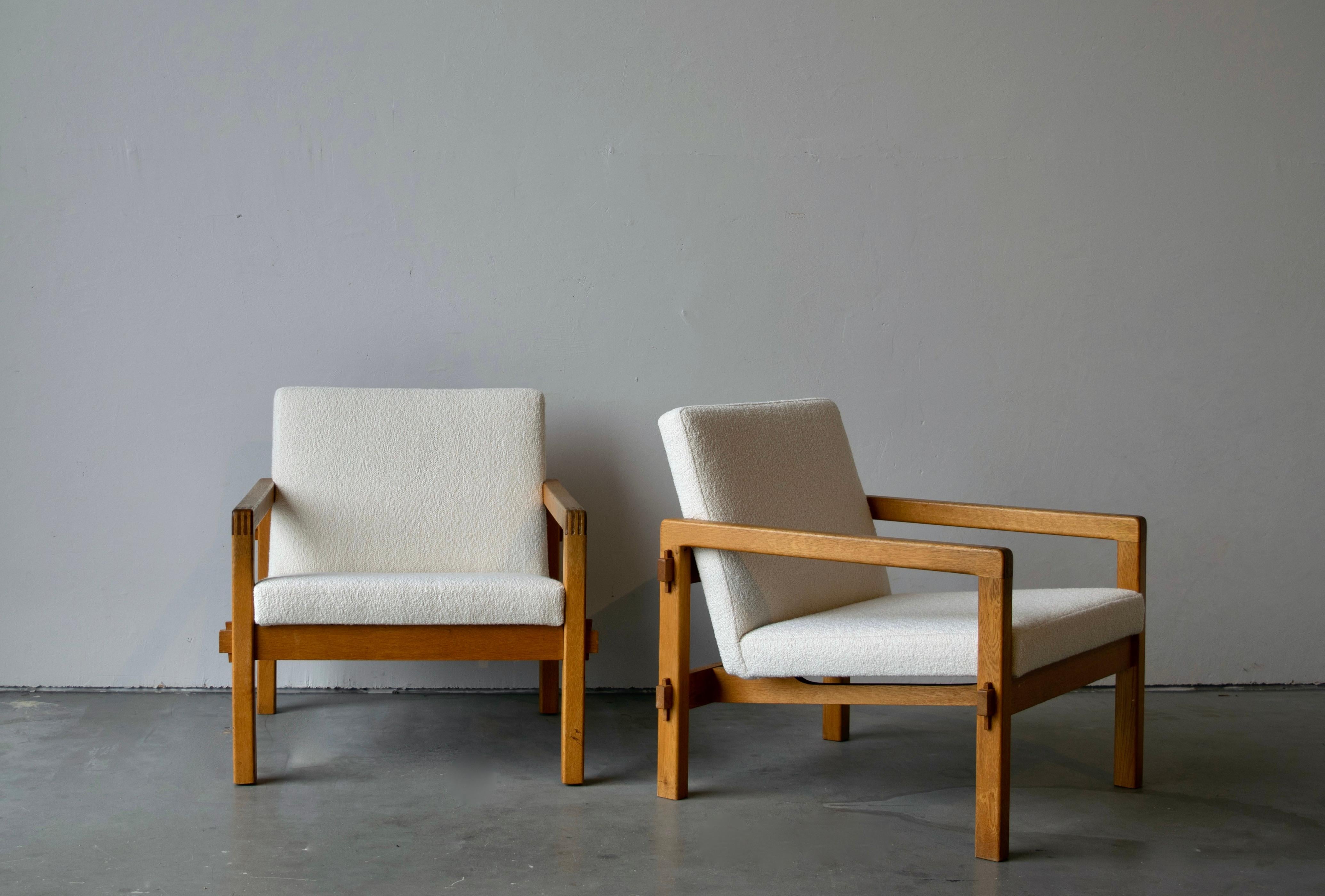 A pair of modernist lounge chairs. Designed by finnish designer Reino Ruokolainen in 1959, produced by Futura Möbler AB, Tibro. In solid oak, with revealed joinery. Reupholstered in brand new high-end bouclé fabric.

Other designers of the period