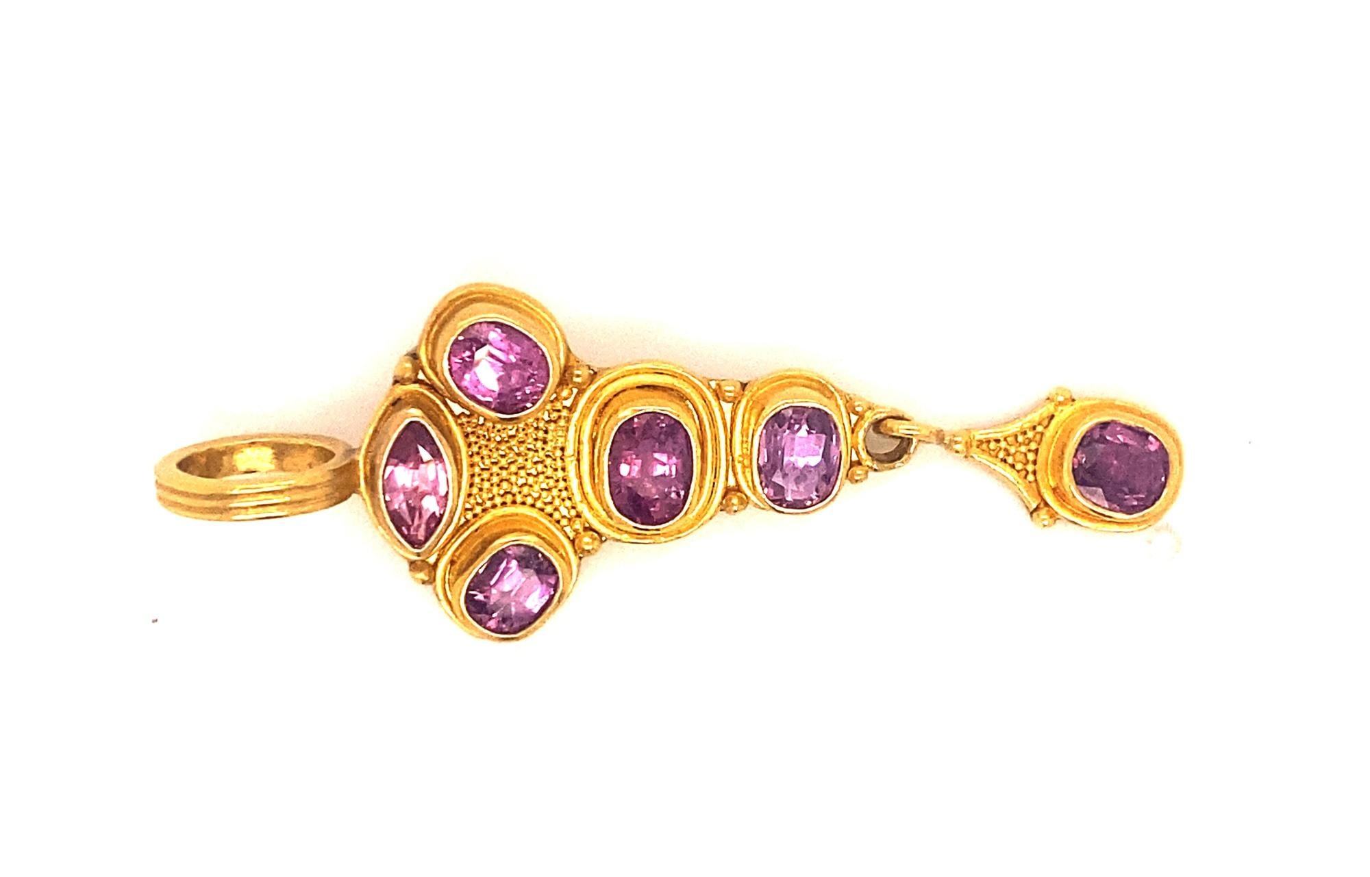 This is a beautiful vintage Reinstein Ross pendant set in 22k yellow gold with oval and marquise shape cut pink tourmalines.  The pendant has gold beading with a large bail.  The 6 pink tourmalines are oval and marquise shaped with amazing color and