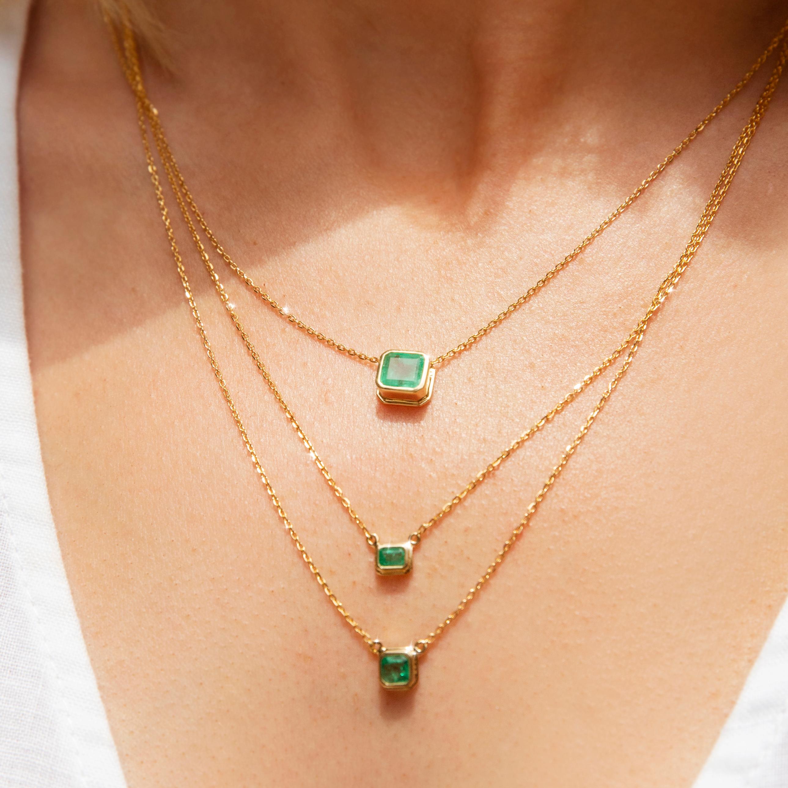 Crafted in 18 carat gold, the charming necklet features a graceful fine chain holding a lovely bright square cut emerald in a bezel setting. Her name is The Petunia Pendant. She is light and comfortable to wear and a perfect choice for lovers of
