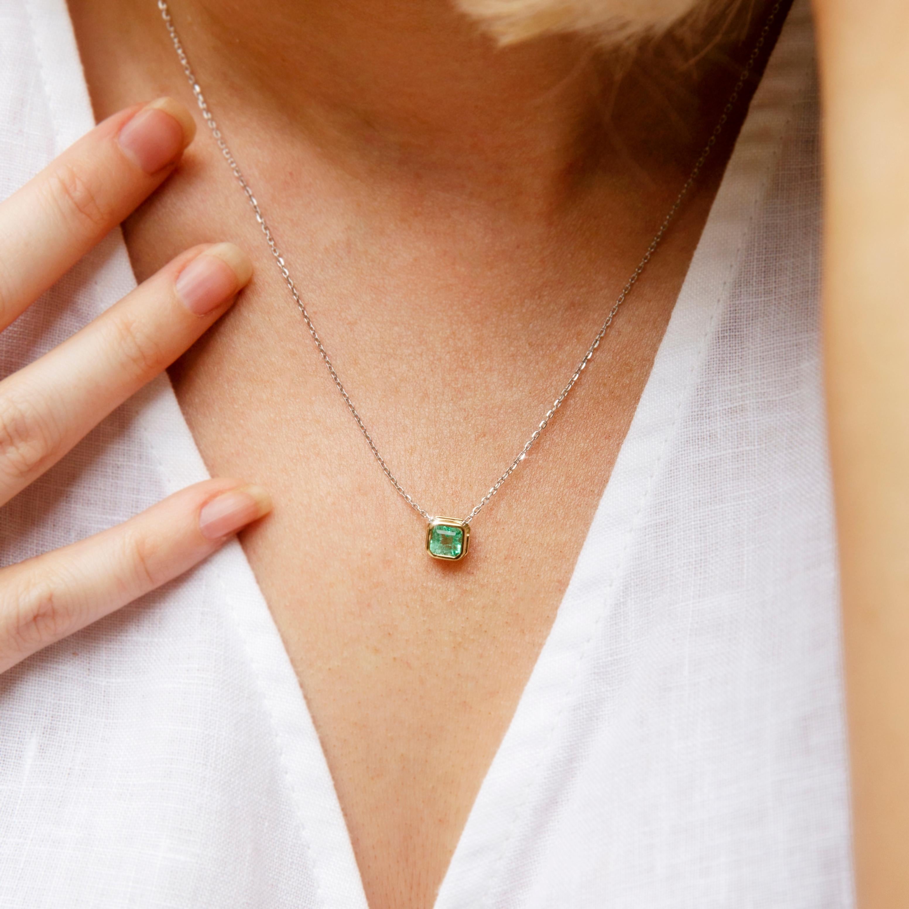 Crafted in 18 carat yellow gold, the lovely necklet features an elegant fine white gold chain holding a gorgeous square cut emerald in a yellow gold bezel setting. Her name is The Kyria Pendant. She is a wonderful choice for light and comfortable