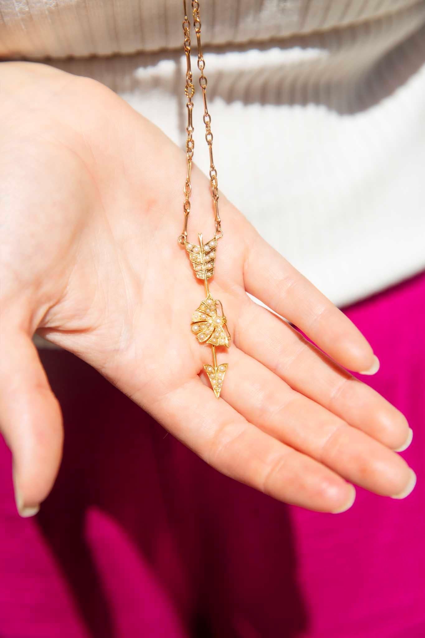 Lovingly crafted in 14 carat gold, this gorgeous pendant is a reinvented 1960s pendant. The whimsically captivating arrow setting, marked midway with a delightful butterfly, is set with adorable seed pearls.  

The Trina Pendant & Chain Gem