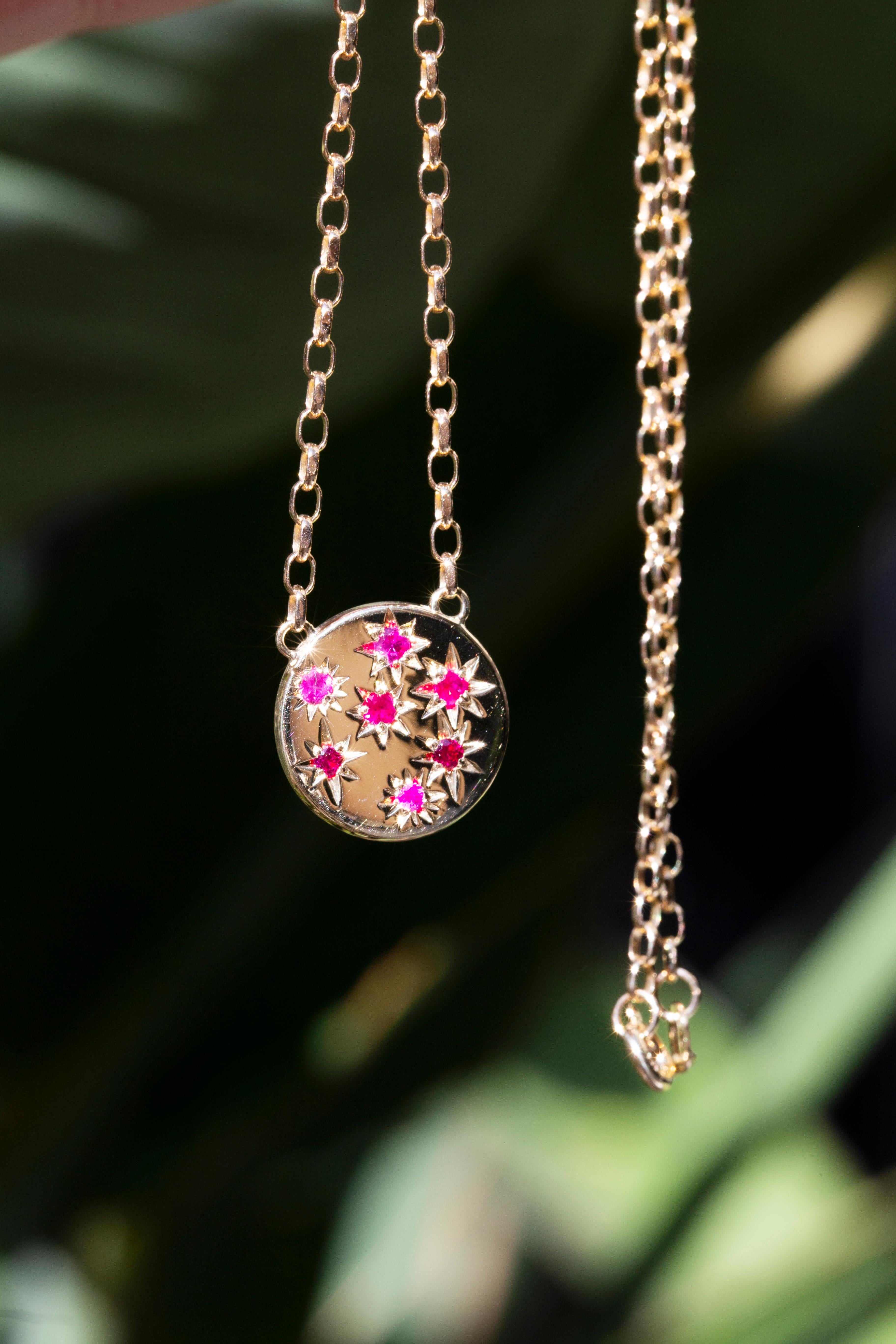 Crafted in 9 carat yellow gold, this adorable and elegant reinvented vintage necklet features a disc setting holding seven bright vivid hammer set rubies and is threaded with a lovely oval link chain. Her name is Rosa, and she is a gorgeous love