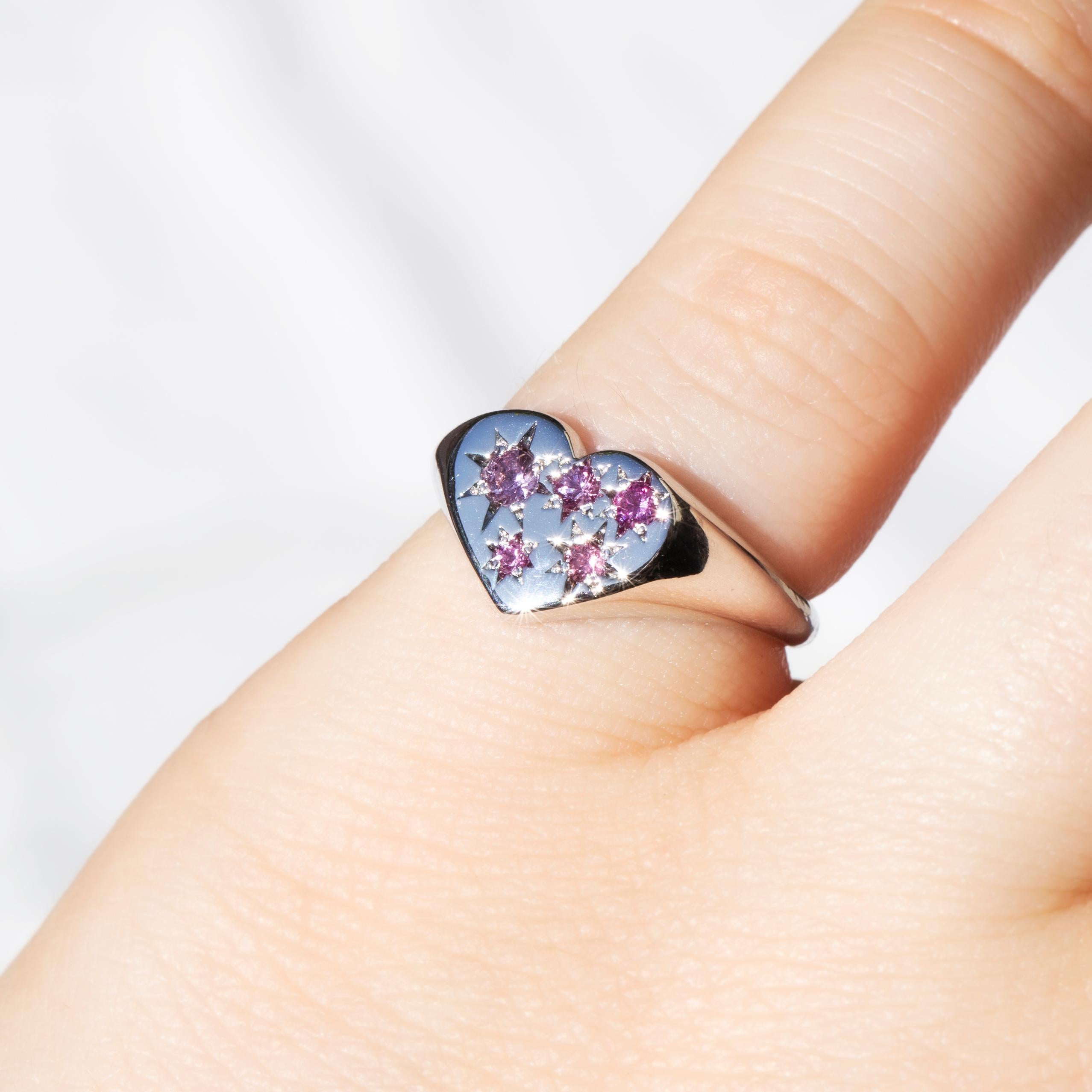 Crafted in 9 carat white gold, this adorable reinvented vintage ring sees a shimmering band widen to a heart-shaped top set with faceted round sapphires in shades of pinks and purples. Her name is Indira, an affectionate symbol of the sanctity of