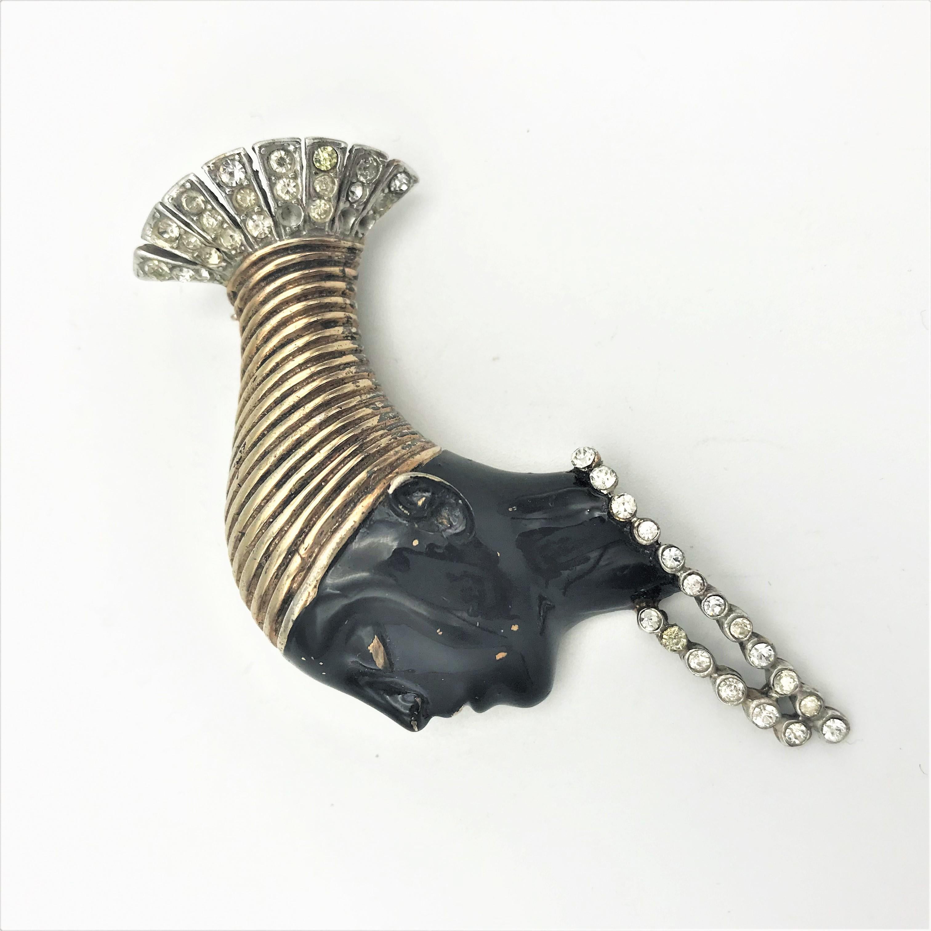 About
an other Africana 'Nubian Head' wearing a necklace ,features giossy black enamel and metallic.Sterling vermeil NY 1946
Measurement
Higth 7 cn 
breadth of face 2,5 cm 
necklace 2,5 cm long
Features
- original Reja, designed by Solomon