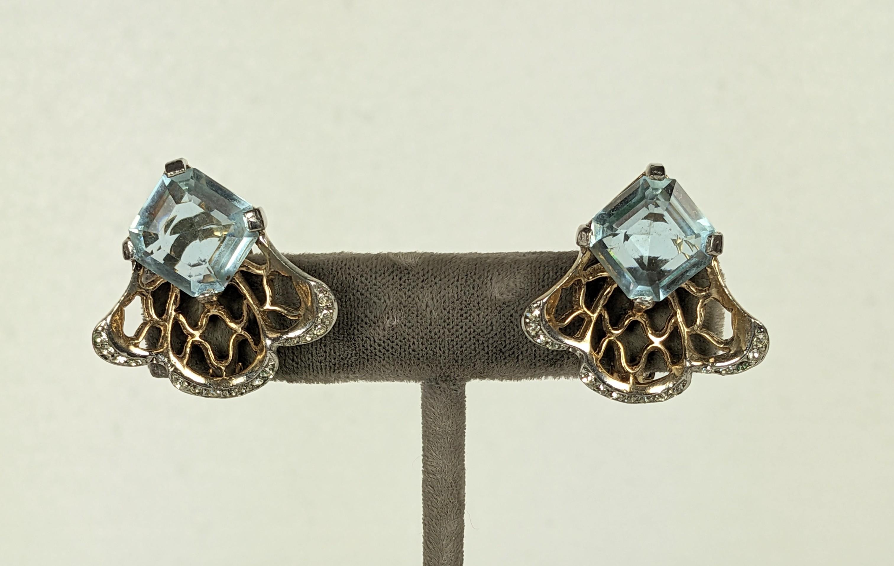 Reja retro earclips of a focal faux pale blue amythest , with crystal baguette accents and crystal rhinestone pave. Set into a Retro inspired fretwork shell of pale pink gold plate over rhodium plate base metal. Good Condition, Clip back fittings.