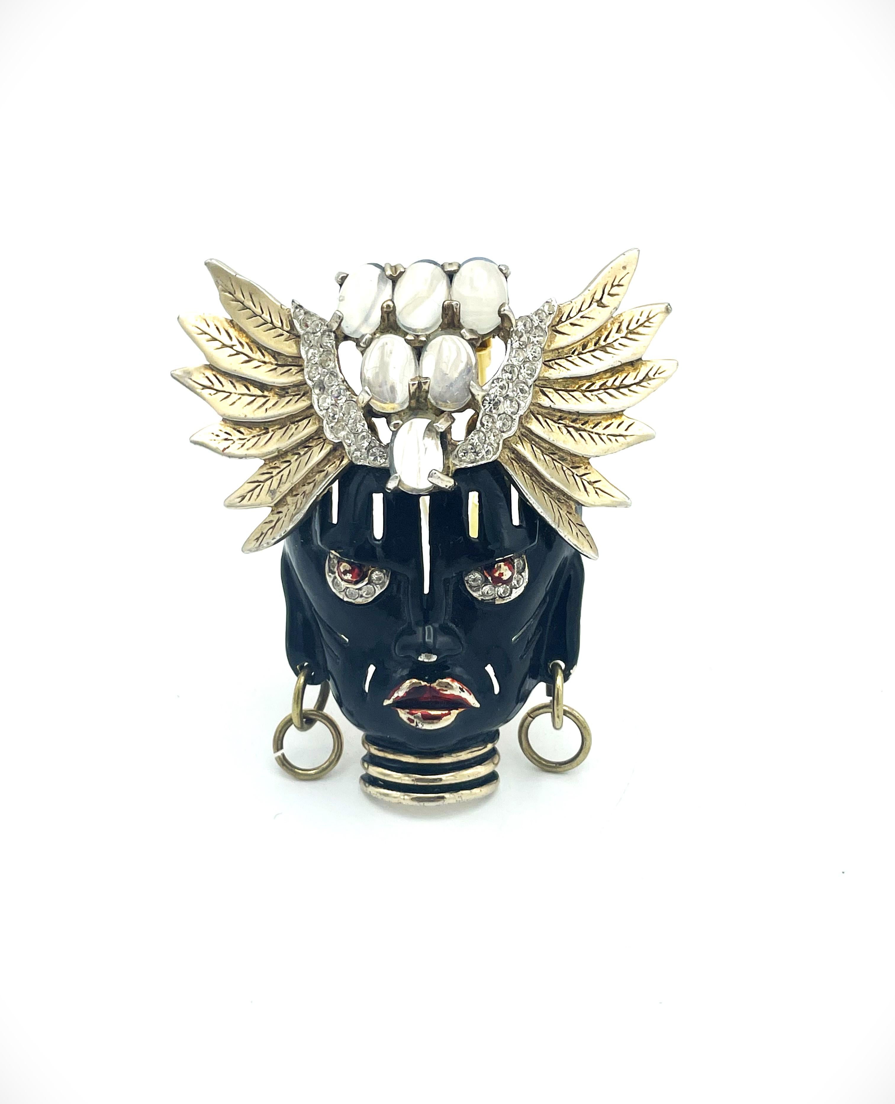 About
Exquisit 1945 Solomon Finkelstein for Reja 'Ubangi' pin from the 'Africana' collection. The wonderful dimensional mesmerihzing face features glossy black fenamel and a meztallic red mouth and piertcing eyes. Clear rhinestones under the eyes.