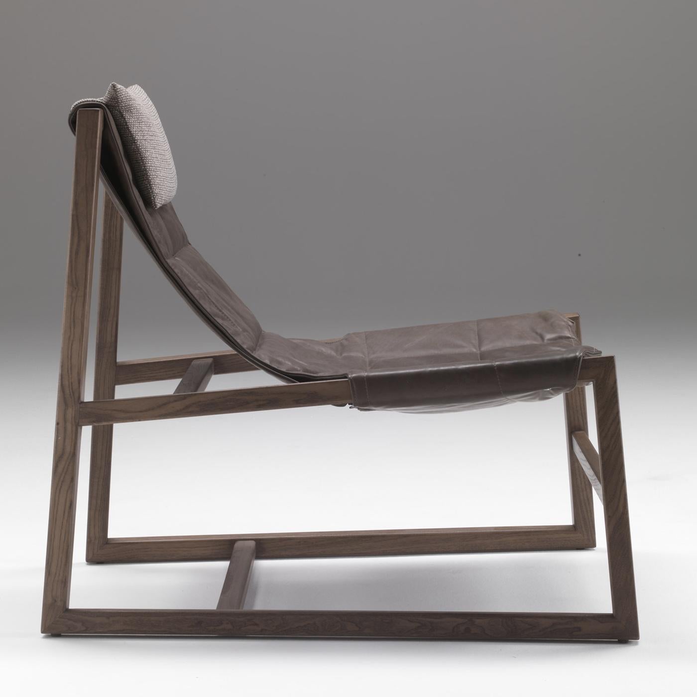Designed by Controdesign Studio, this lounge chair boasts a bold yet elegant design that will make it stand out in any contemporary or industrial setting. Its solid ash structure combines horizontal and diagonal elements that supports a brown