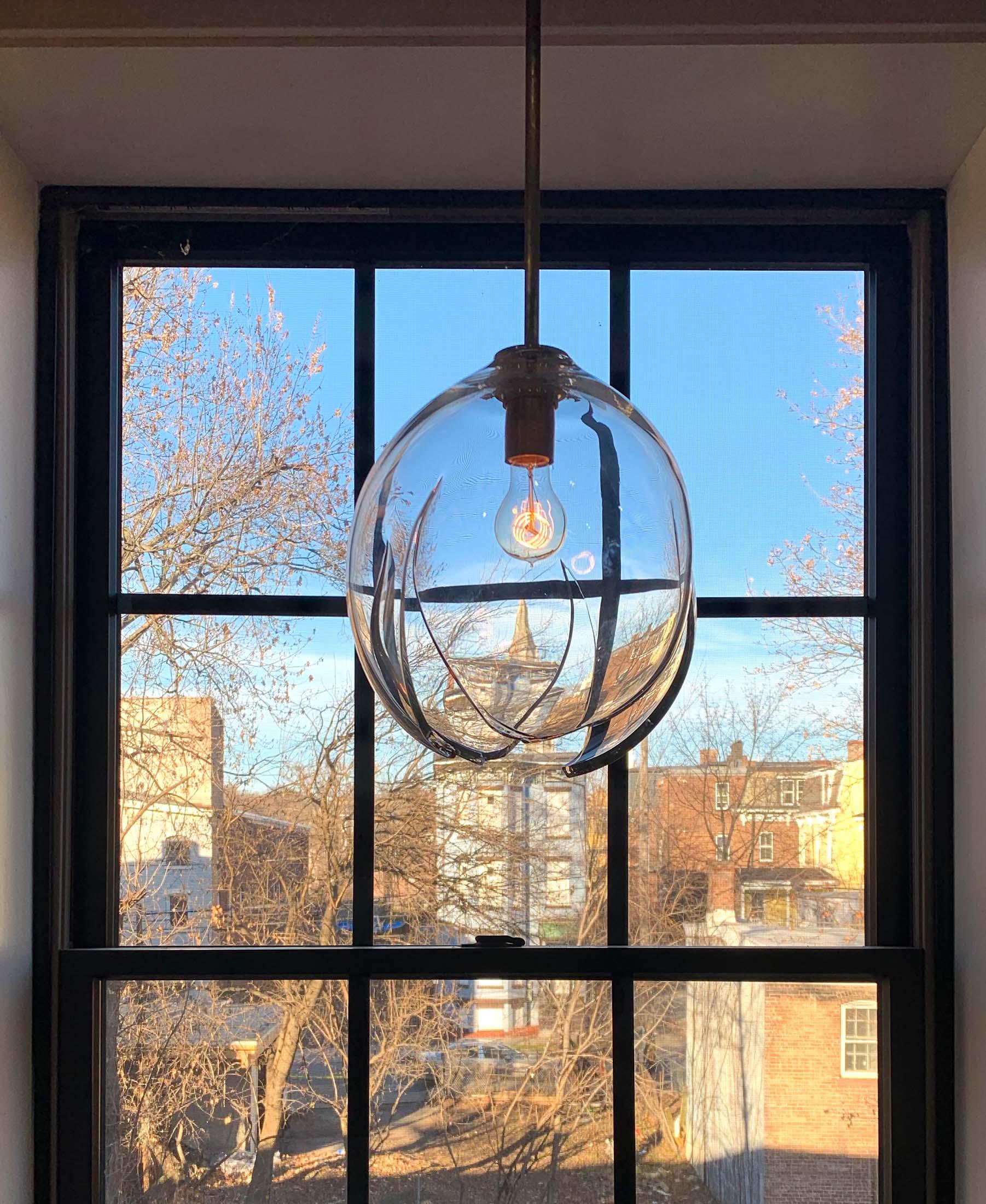 Release is an expressive light fixture formed using a delicate cooling technique to create a fractured opening. During the blowing process, an area of the form is meticulously cooled down until it naturally ruptures, thus releasing the stress