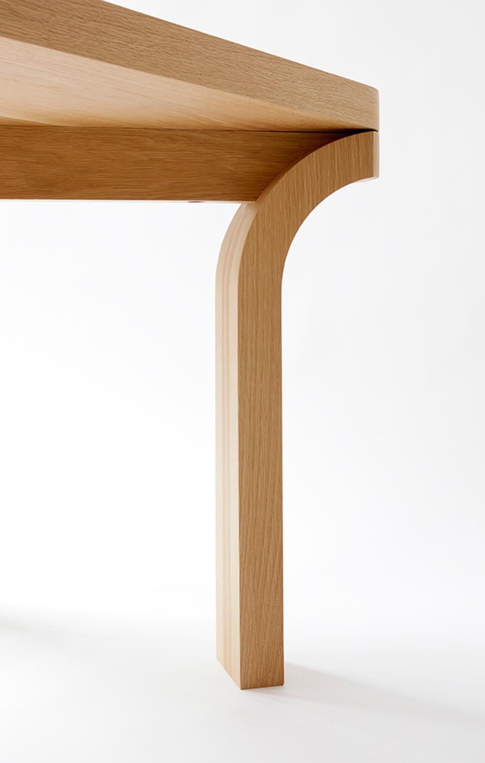 The Relevé dining table was conceived from the outside corners
in, inspired by a ballet dancer's pointed stance, sturdily poised and
arched outward. The piece is constructed out of solid white oak.
The angled stretchers, bisecting the 