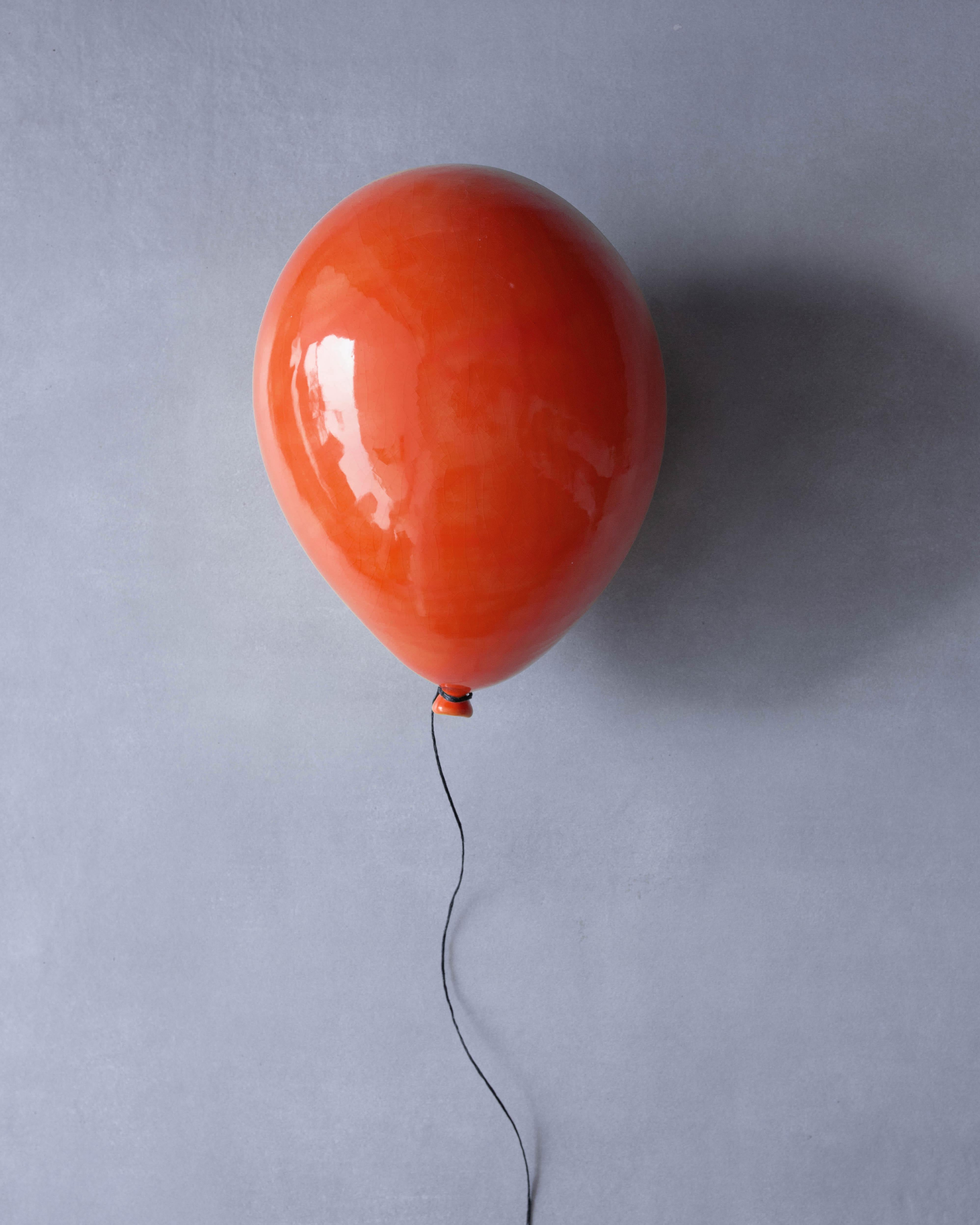 Deep Orange glossy ceramic balloon sculpture handmade for wall, ceiling