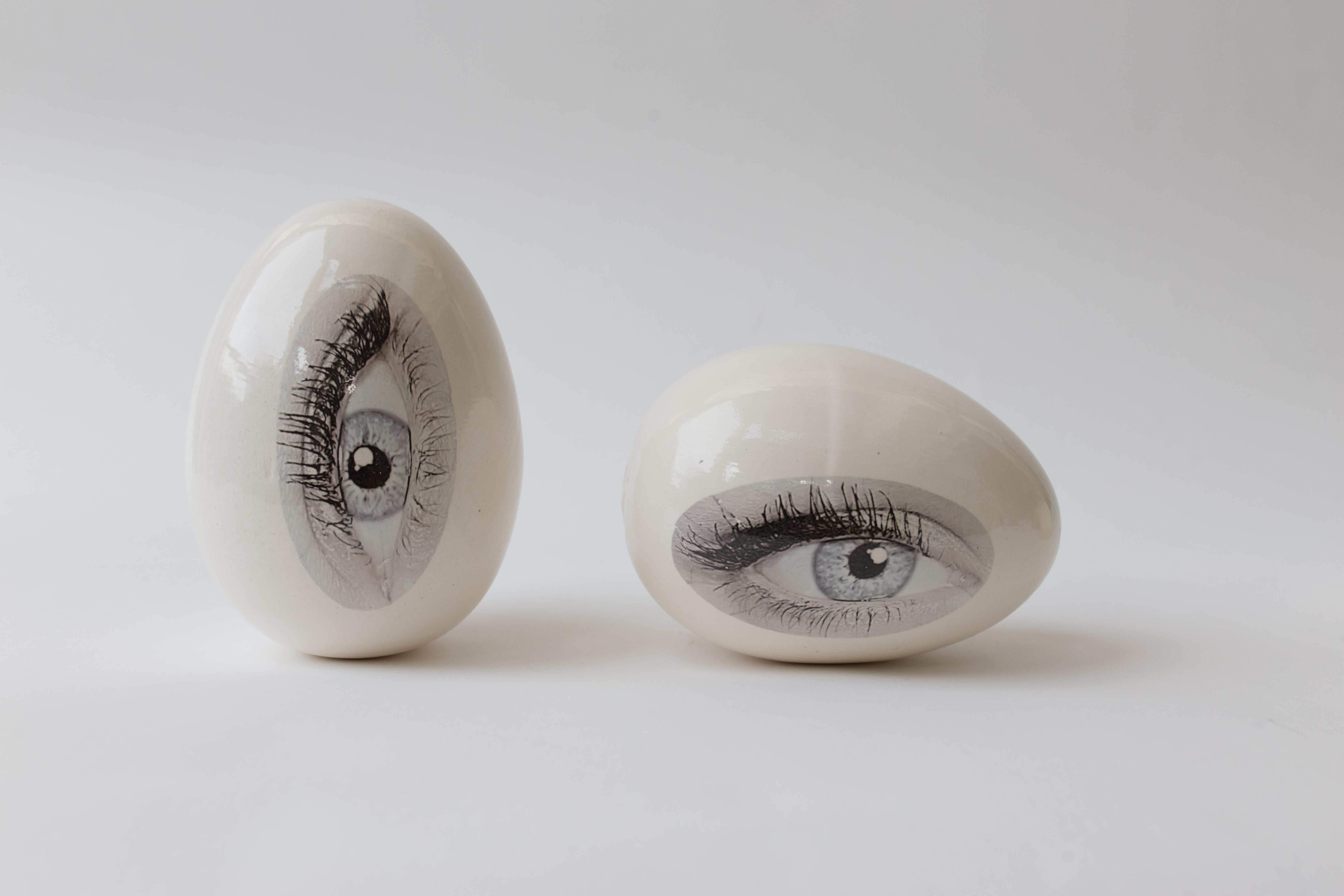 Reli Smith and Osnat Yaffe Zimmerman Figurative Sculpture - Good eye ceramic egg sculpture, Pair of 2 eggs. One standing and one lying down