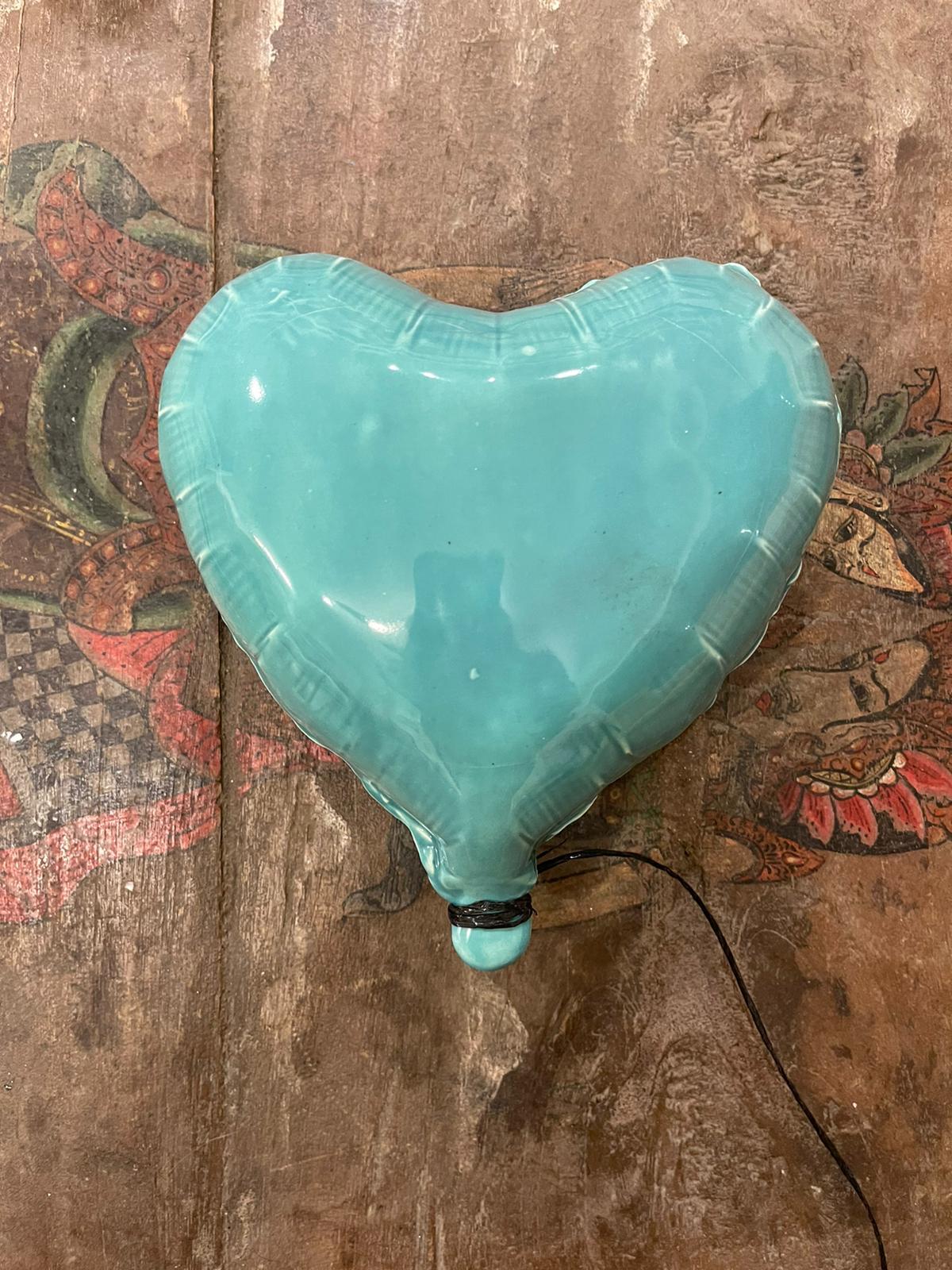 Good Eye glossy ceramic heart balloon sculpture handmade for wall installation - Brown Figurative Sculpture by Reli Smith and Osnat Yaffe Zimmerman