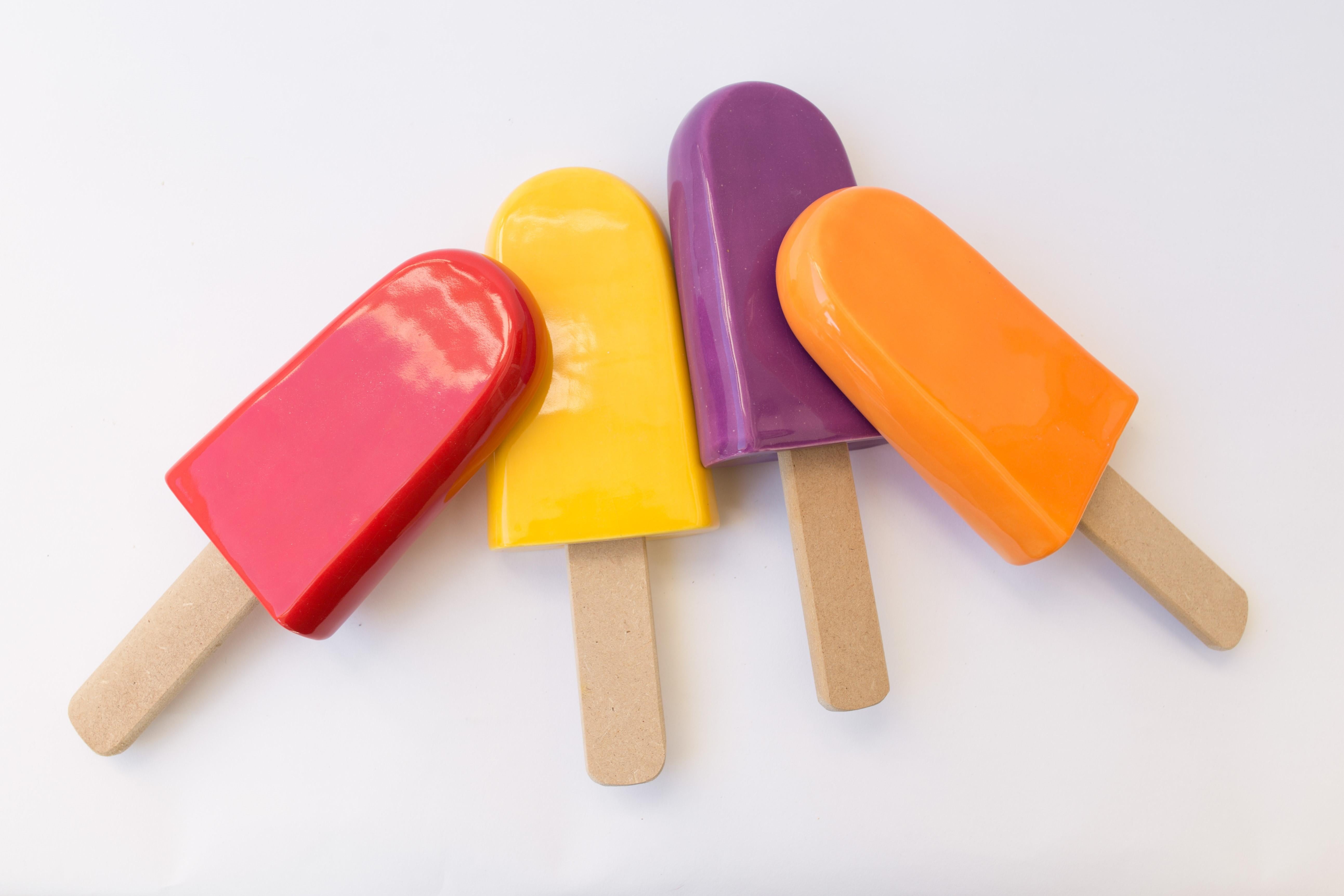 Set of 12 glossy ceramic popsicles wall hanging - Contemporary Sculpture by Reli Smith and Osnat Yaffe Zimmerman