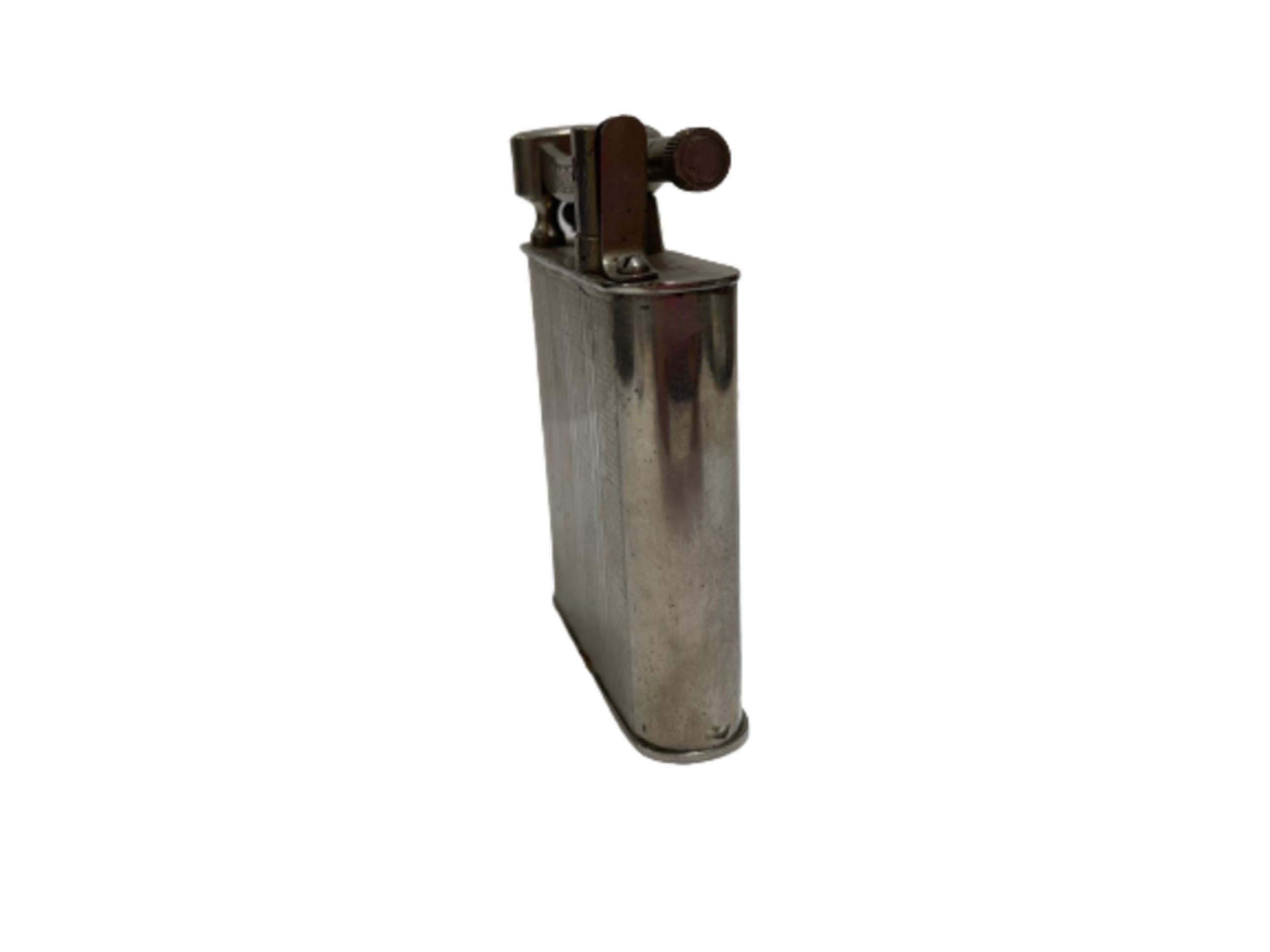 Post war lift arm chrome pocket benzine lighter by Reliance

Text on bottom of lighter: 