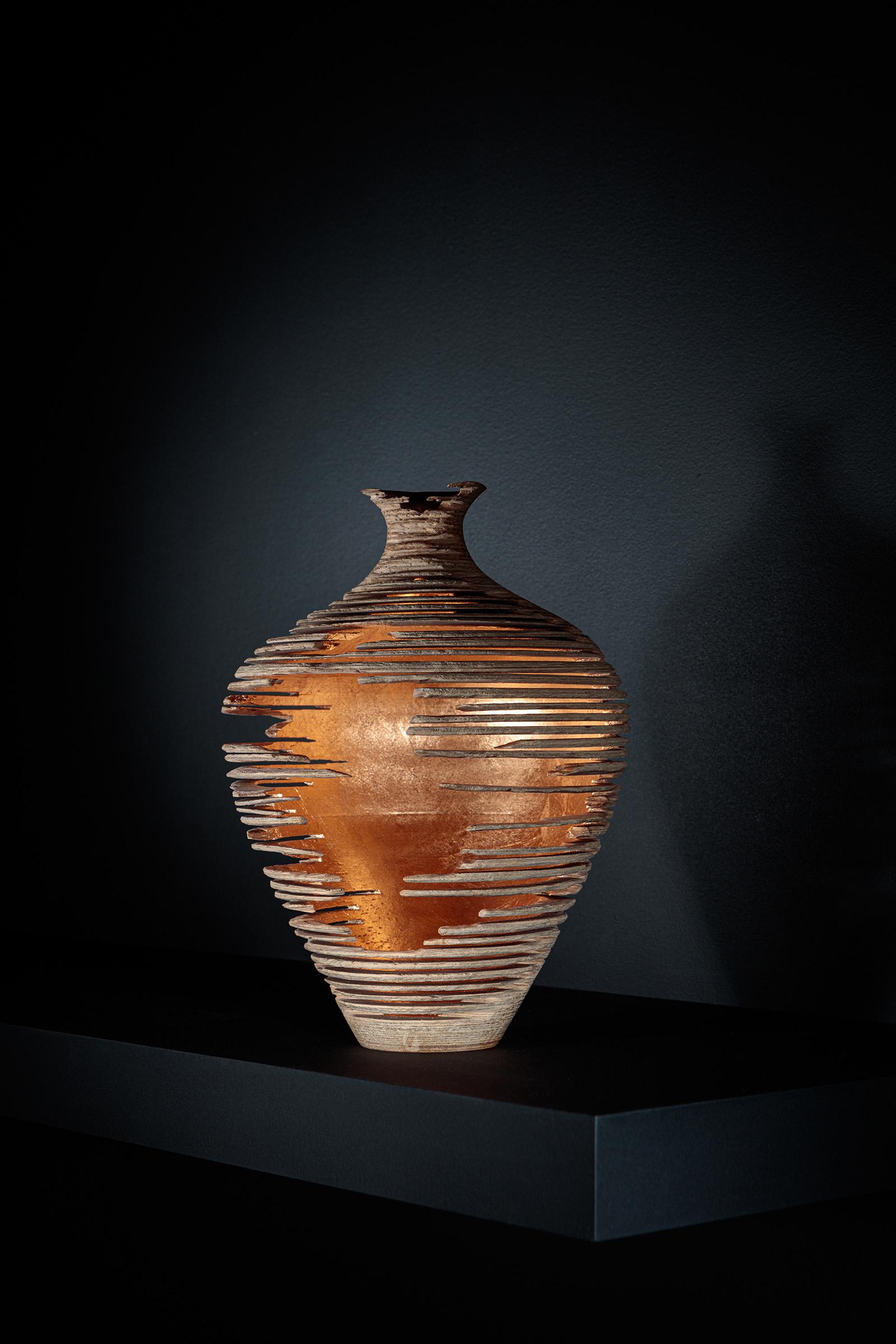 Marc Fish's Relics series of Vessels are assembled using 500 layers of laser cut veneer. This could be ash, oak, walnut or black ash layered to produce a vessel form and then carefully deconstructed using modern methods before hand carving and