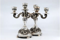 Relief silver candelabra with shells, three lights and circular bases with feet