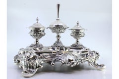 Relief silver inkwell with plant motifs, tanks & four decorated feet