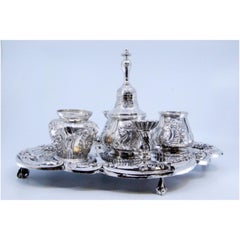 Relief silver inkwell with tanks, bell & four claw-shaped feet