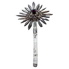 Relieved silver splendor with fake purple stone in cut form