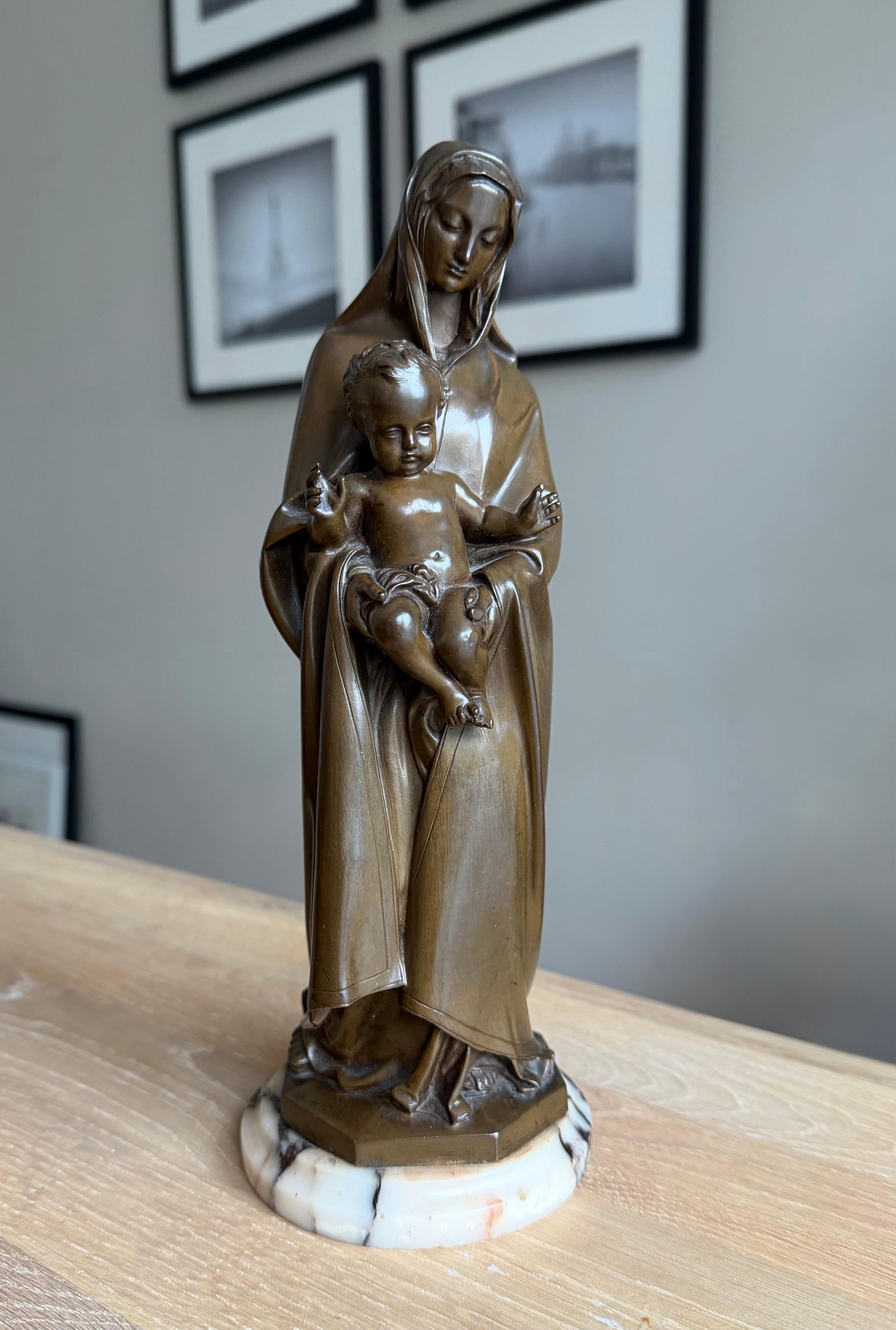 Élégante, significative et profondément sereine, cette œuvre d'art religieux raffinée porte en elle à la fois la maîtrise artistique et le symbolisme spirituel.

Cette Vierge à l'Enfant en bronze finement modelée date du milieu ou de la fin du XIXe