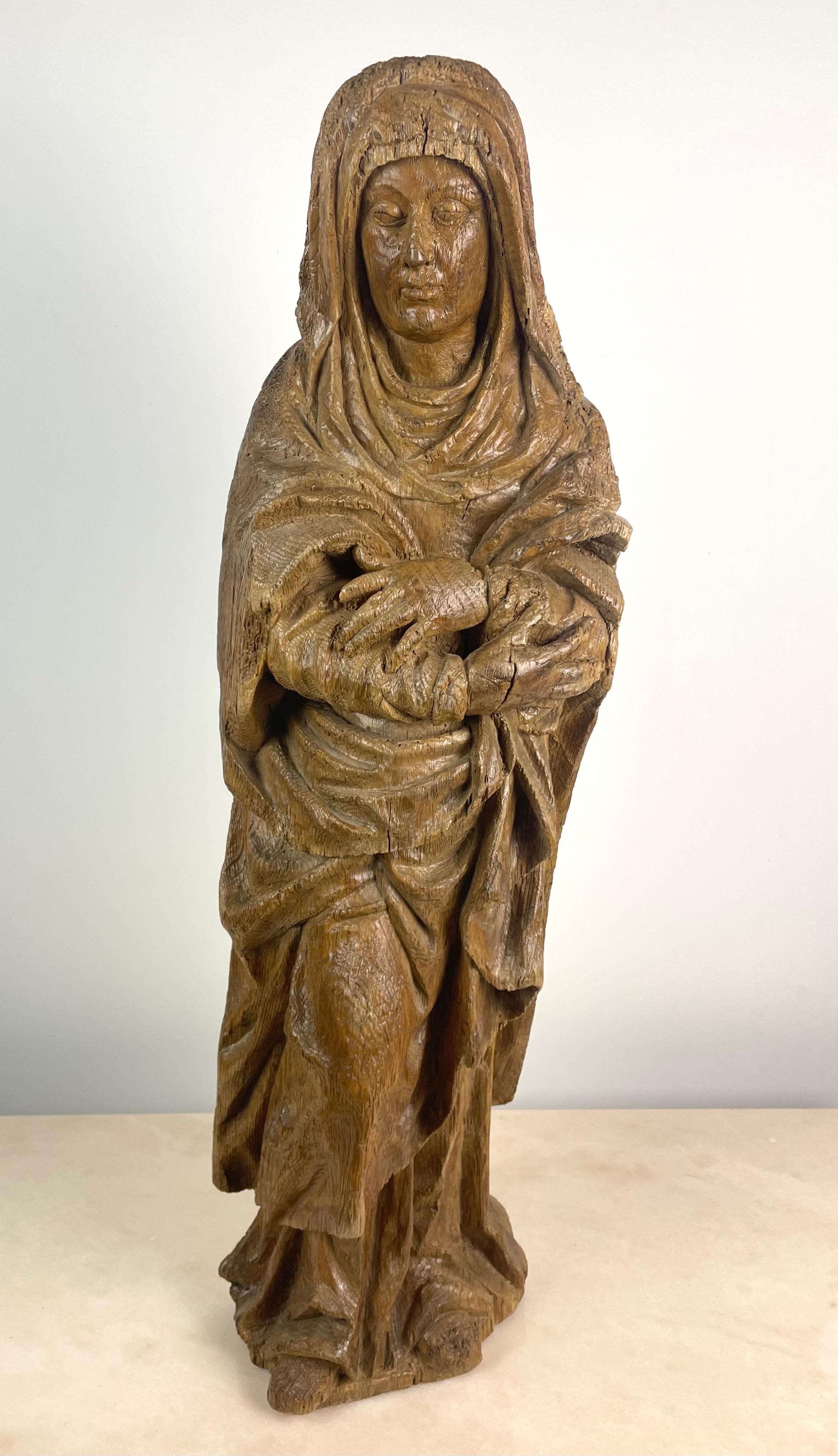 Beautiful and large sculpture of a saint, probably Saint Véronique, in hand-carved natural wood. Beautiful religious object.
Standing, she has her head down and her arms crossed in front of her chest.
She is dressed in a heavy veil overhanging her