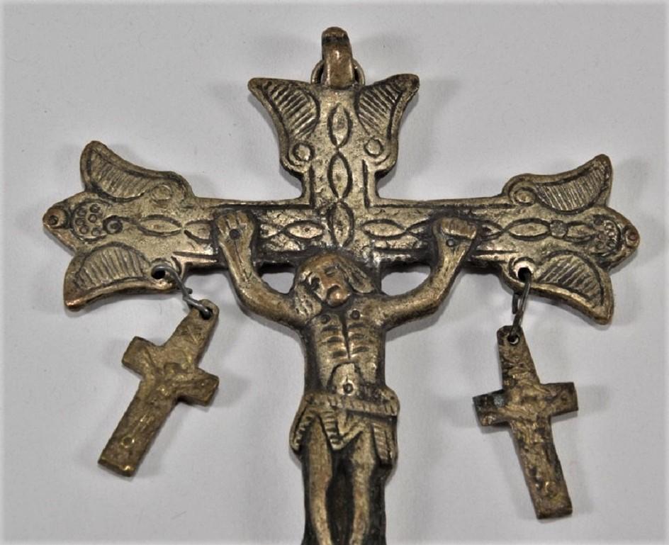 A reliquary bronze crucifix on large engraved cross pendant with two hanging small crosses at both lateral sides of the large cross, Italy, early 17th century. Both small crosses with engraved Jesus Christ corpus. It appears that the bronze has been